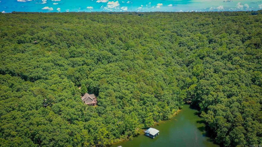 Stunning Lakefront Retreat with Private 2-Stall Boat Dock on Greers Ferry Lake. Welcome to your dream lakefront oasis! Nestled on a tranquil stretch of Greers Ferry Lake, this remarkable home offers the ultimate blend of relaxation, recreation, and luxury lake living. Featuring a private 2-stall boat dock, you’re ready for all of your water adventures right outside your door—whether it’s boating, fishing, swimming, or simply soaking up the peaceful views.  This beautifully designed residence boasts 4 spacious bedrooms and 4 full baths, making it perfect for hosting family and friends. The main living area impresses with soaring vaulted ceilings, custom solid wood doors, and an inviting open floor plan designed for both entertaining and everyday comfort. Enjoy morning coffee or evening sunsets on the expansive wrap-around deck, where you’re treated to panoramic views of the lake and the serene, tree-lined surroundings. Whether you’re hosting a barbecue or unwinding with a good book, this outdoor space is sure to become your favorite retreat. Located on a quiet, sought-after part of Greers Ferry Lake.  Could be sold fully furnished.  Schedule your private showing today.