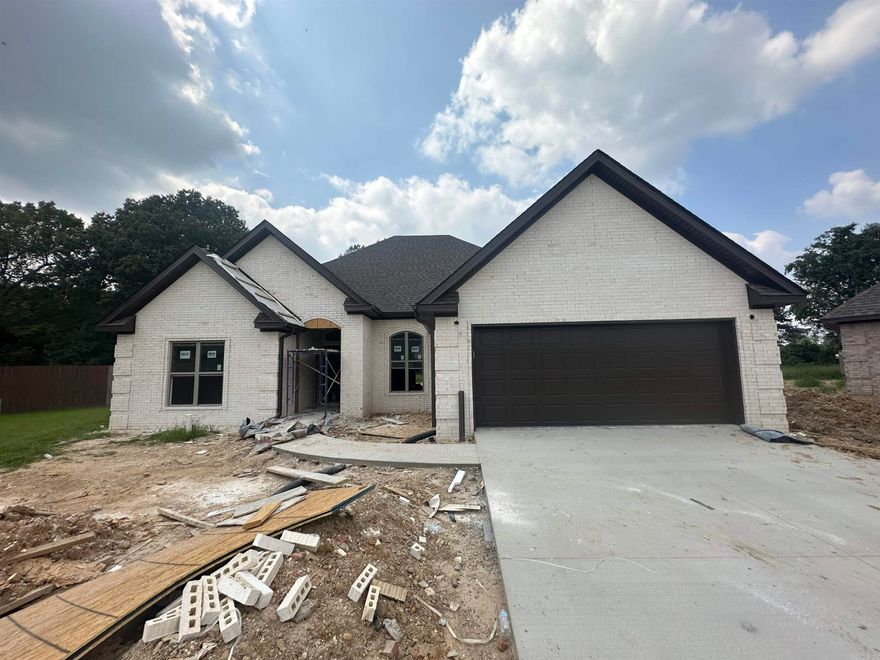 Beautiful - Spacious - New Construction - Brick Four bedroom, two bath home with open concept and split floor plan. Kitchen has abundance of cabinets, granite countertops, pantry and breakfast area that leads to the screened porch with woods in the back for privacy. Living Room with custom trim and molding is open to kitchen and features fireplace. Master bedroom is spacious with tray ceiling, trim and molding. Ensuite bath has double vanity with granite countertops, soaking tub, and tiled walk in shower. Ensuite also has large walk-in closet with wood built-ins . The other three bedrooms are on opposite side of home with bathroom with double sink and granite countertops. As you walk in from double garage, you there is a cubby for organization and laundry area.  Pictures will be updated as home construction progresses. Agent owned, listing agent is related to seller.