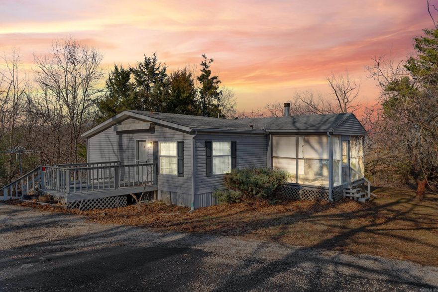 Convenience of town just minutes away! This 3 bedroom, 2 bath mobile home sits on 1.37 acres m/l and offers a great blend of comfort and functionality. Features include a cozy fireplace, a screened-in porch perfect for relaxing, and a wintertime lake view to enjoy the changing seasons. The property is equipped with a carport and a generator for added convenience and peace of mind. Plenty of room to spread out while still being just minutes from shopping, dining, and everyday amenities. A great opportunity for affordable living with space, privacy, and a scenic setting.