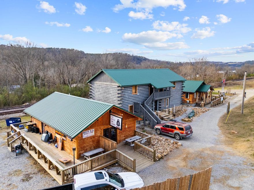 Exceptional turnkey opportunity to own THREE newly constructed commercial buildings (2024) in the highly desirable and charming town of Norfork, AR! This unique property combines income-producing commercial space, short-term or long-term rentals, and an established tenant making it an ideal investment for diversified cash flow. The property includes the Rusty Rail Saloon, a beer and wine only bar,    offering a welcoming atmosphere and strong local appeal. Also featured are 4 Airbnb/rental units, the building itself being thoughtfully designed and modeled after the historic Jacob Wolf House. Additionally, the property is home to Norfork Family Medicine Clinic, currently occupied under a yearly lease, providing stable, dependable income. Ideally located across from Norfork Brewery, this property benefits from excellent visibility and consistent traffic. Just minutes from the world-famous White River, the location perfectly attracts tourists, outdoor enthusiasts, and locals alike.