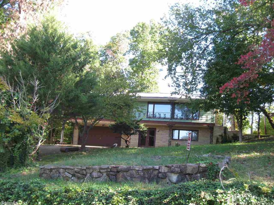 NEW PRICE!!! LARGE FAMILY HOME!! This large home sits in a private location yet is close to lake and golf course! Over 2500 sq. ft. of living space with open floor plan, large living room with wood burning fireplace, full length covered front porch (new deck boards in 2015), good size laundry room, huge family room also has fireplace and wet bar, 2 car attached garage all on 2 lots!!