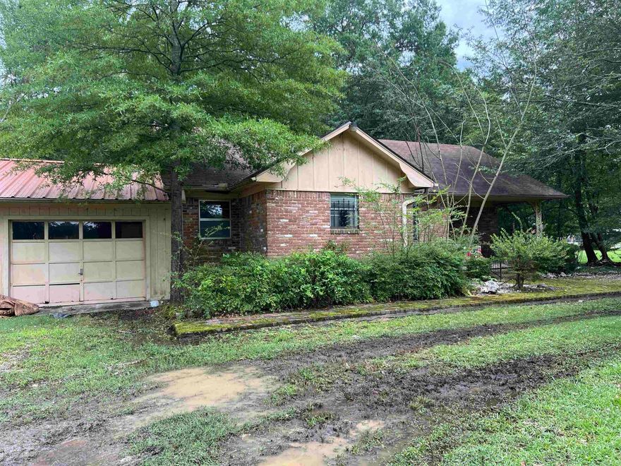 Fixer upper located near the hospital on 3 Acres.