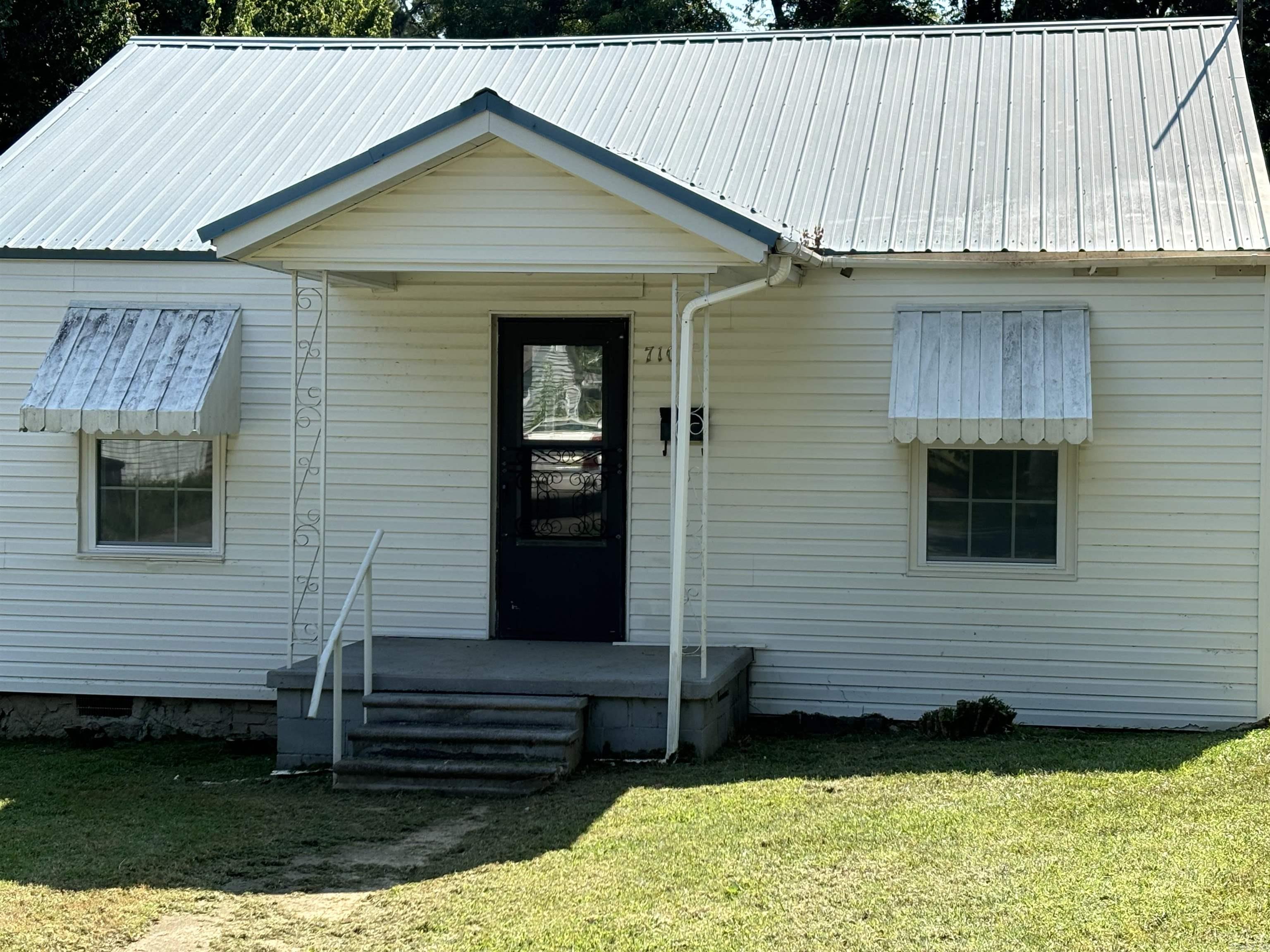 Don't miss this updated 3 bed/2 bath house. Perfect for a starter home, rental or for someone looking to downsize. This house has NEW WINDOWS, updated electrical, a screened in back porch, shop, two cover parking spaces and a storm shelter. Refrigerator stays, NEW RANGE and a METAL ROOF. This home is handicapped accessible with larger doors and handholds in baths where needed. Large corner lot goes all the way through the block with two large pecan trees in the backyard. Come and take a look!