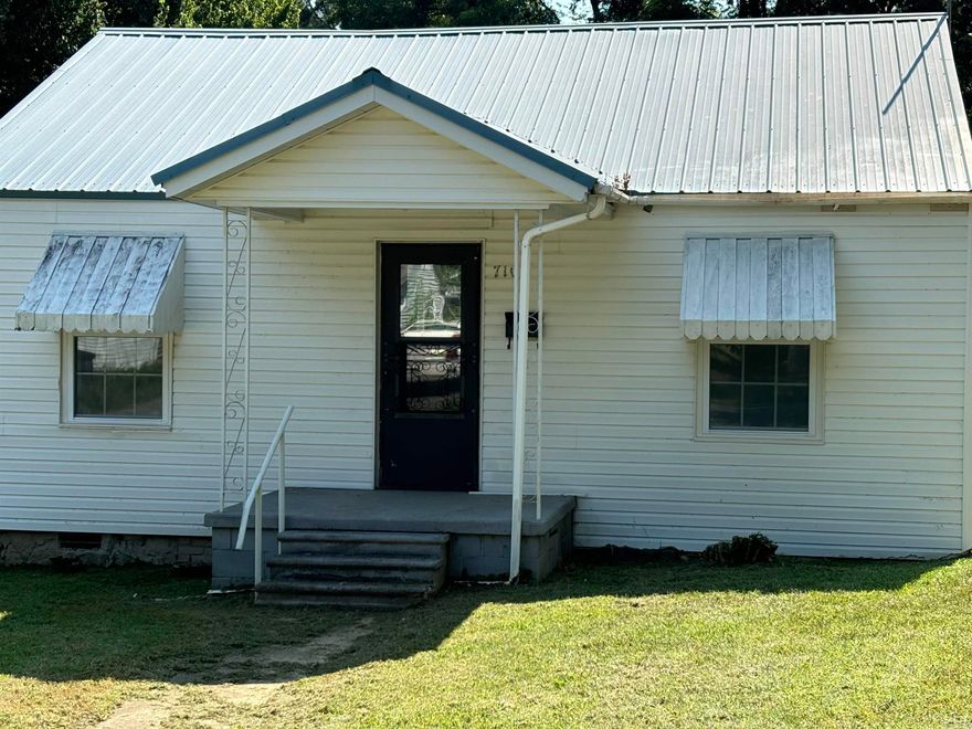 Don't miss this updated 3 bed/2 bath house. Perfect for a starter home, rental or for someone looking to downsize. This house has NEW WINDOWS, updated electrical, a screened in back porch, shop, two cover parking spaces and a storm shelter. Refrigerator stays, NEW RANGE and a METAL ROOF. This home is handicapped accessible with larger doors and handholds in baths where needed. Large corner lot goes all the way through the block with two large pecan trees in the backyard. Come and take a look!