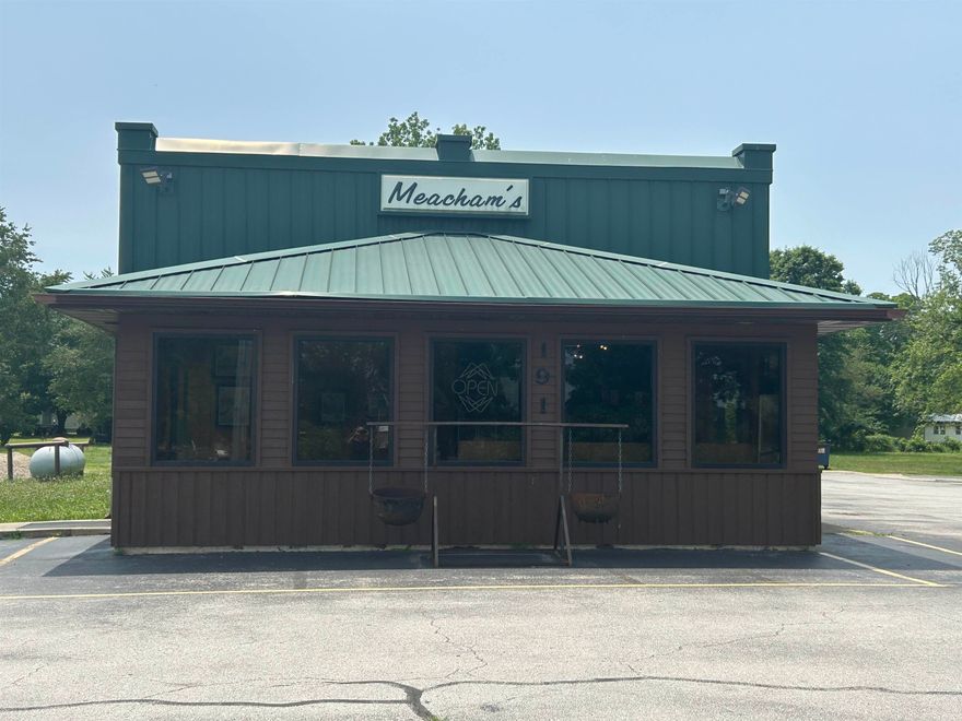 This commercial property sits on 1.5± acres with approximately 250 feet of highway frontage, offering easy access and excellent visibility in a high-traffic location. The 2,000 sq ft building, formerly operated as a beloved family restaurant, features a metal roof and a blend of wood and vinyl siding. Positioned on a mostly level lot, it includes paved parking for 35+ vehicles. Inside, enjoy a comfortable waiting area and a spacious dining room with a beautiful vaulted ceiling that seats approximately 50 guests, furnished with booths, tables, and chairs. The building is equipped with commercial kitchen equipment, two HVAC units, and a combination of concrete, tile, and wood flooring. Additional amenities include two customer restrooms, a private employee restroom, and extra parking for staff. This versatile space is ideal for a restaurant, retail shop, or service-based business looking to thrive in a prime location. (Measurements are approximate.)