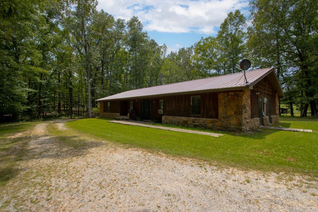 The front of the property has a 30 x 40 shop, follow the driveway to a home with privacy and a barn for all your animals. 3 Bed 2 bath 2070 sqft with a metal roof, large master and living space. The back of the property has a pond, and the current arena is negotiable. The pasture is gorgeous. A small creek runs through the property. There is a mobile home on another part of the property, and it could be rented. If you want to be in the country with 9.85 acres but a few miles from the highway this place is for you. SEE REMARKS
