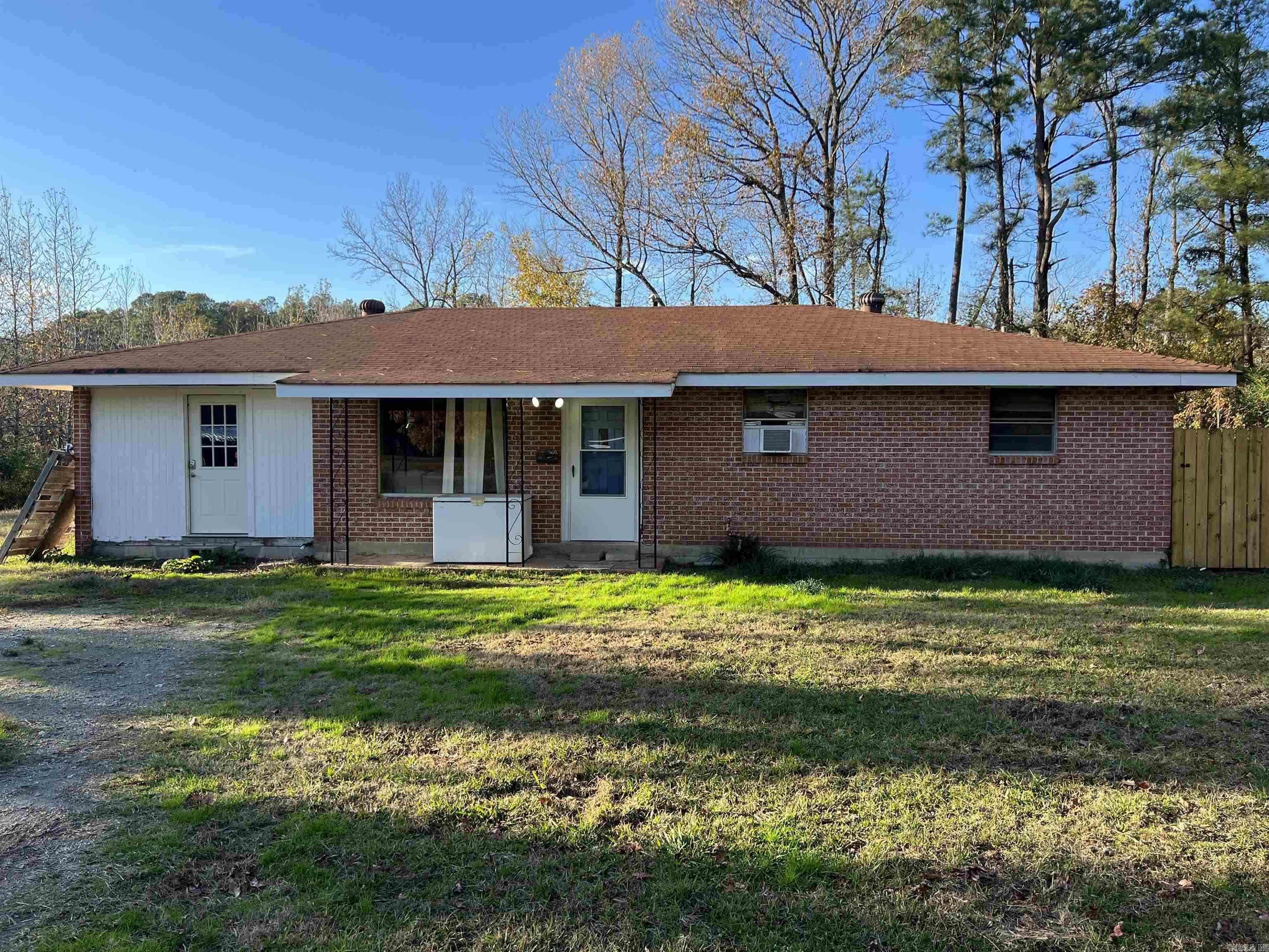 This 3 bed 1 bath home sits on almost an acre and a half and radiates potential for someone willing to update it to its full potential. The layout is simple yet charming and features a modes kitchen and living area and nice size bedrooms and utility room. The home has central hvac and window units for added comfort.