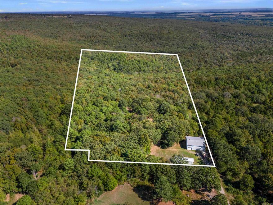 Looking for peaceful country living with space to spread out? This property offers nearly 20 acres outside the city limits with no restrictions, giving you the freedom to build your dream home or place a new mobile home. Utilities are already in place — water, septic, and electric are installed and ready to go. The property has its own driveway and another driveway on the other side for convenience. Also, much of the land is wooded, making it an ideal spot for hunting or creating your private retreat. A 50x45 shop with two large garage doors, electricity, front and back doors is included and features a half bathroom that’s already connected to the septic system — 1/2-bathroom does need finished out. Enjoy peace, privacy, and endless possibilities with this one-of-a-kind property! There is another flat spot on the land down from the shop that could be a great spot for a home, but someone would need to work on utilities for that spot. Seasonal creek runs on the property! Beautiful trees! The current mobile home can be removed before closing, and all items in the shop and equipment on the land will be removed from the property prior to closing. Property lines are approx. in photos!!!