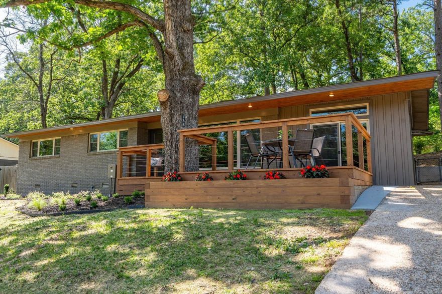 136 Buster Reed Drive offers stylish, modern living with an unobstructed lake view and a 18' dock directly across the street. This professionally renovated modern ranch features generous decking, wire railing for a seamless view, tongue & groove accents, and fresh landscaping for standout curb appeal. The front yard was recently hydroseeded for a lush lawn in no time. The fenced backyard and patio are perfect for pets.   Inside, enjoy an open-concept living/kitchen area, large dining/entertainment room, 3 bedrooms, 2 baths, and a spacious laundry room.  Primary suite has oversize walk-in closet and walk-in shower. Water views are visible from the living room, kitchen, dining, and two bedrooms. High-end finishes include custom tile, walnut & quartz countertops, refinished hardwoods, stainless appliances, ambient lighting, and curated fixtures.   Updates include new HVAC, roof, electrical, plumbing, cabinetry, windows, decking, and retaining walls. The permitted 18' floating dock (6' water depth as of 5/16/25) was recently re-decked.   No surprises here, this property is just as beautiful in person as it is in the photography. Ask your realtor for the full list of upgrades!