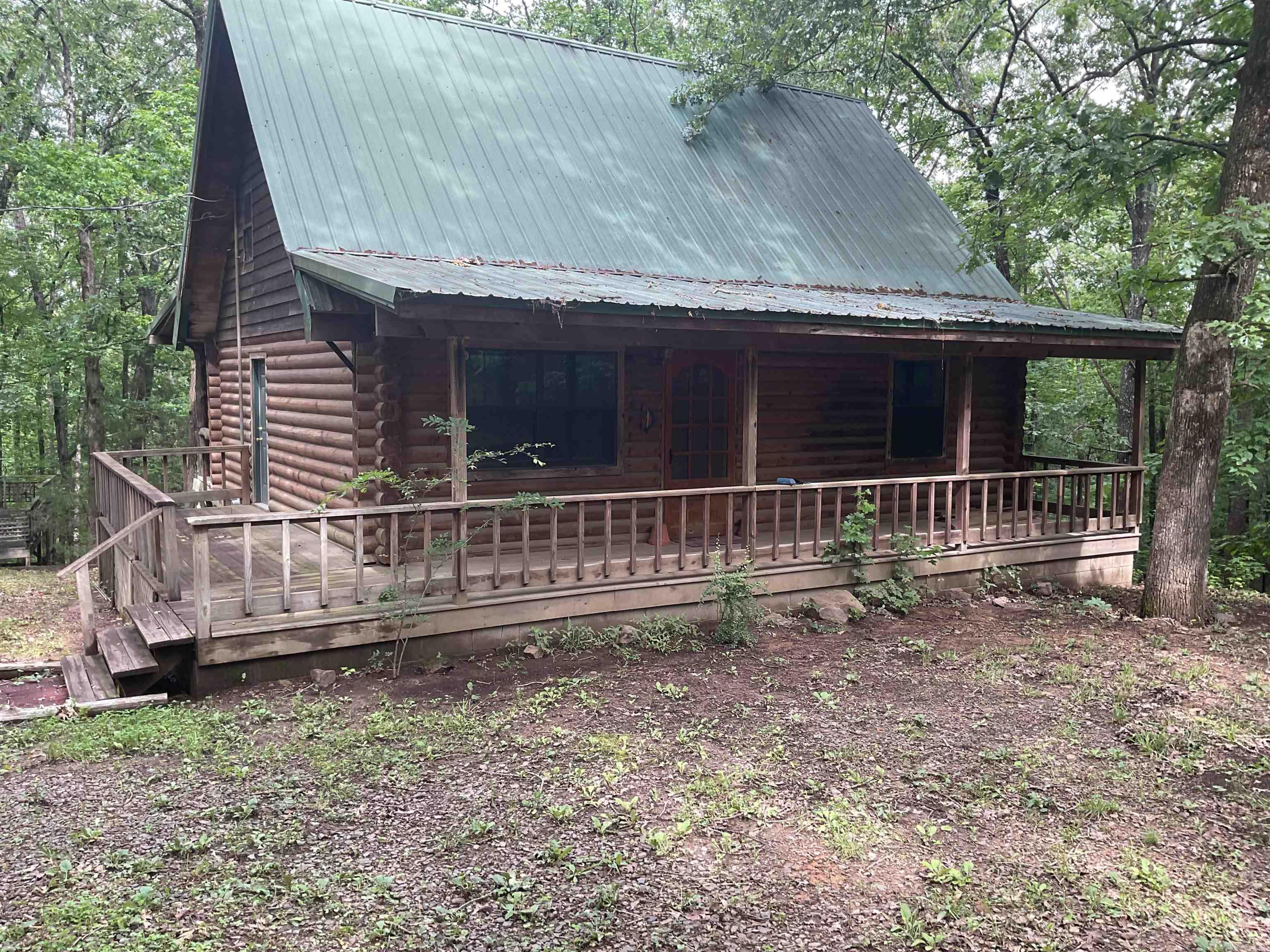 LAKEFRONT CABIN ON GREERS FERRY. What a great cabin at a great price. Main level has open den/dining/kitchen with large breakfast bar & patio doors to rear deck, Upper level has loft space, bedroom & 1/2 bath. Lower level has 2 bedrooms, full bath, large laundry & outside patio area. Kitchen has lots of counter space, elec. range, refrigerator & lots of cabinets plus a large dining area. Nicely situation in a private setting and gentle walk to the water's edge you will enjoy the rear deck, covered front porch and a separate detached deck area. FURNISHINGS NEGO. Just minutes from launching your boat at Sugar Loaf Marina or keeping your boat in a boat slip at the Marina (which is full service). GREAT CABIN, GREAT LOCATION, GREAT PRICE.