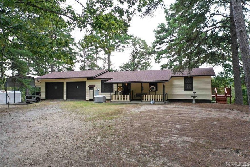 Nestled on nearly 5 acres of serene, wooded landscape, this beautifully maintained one-level home offers the perfect blend of comfort, privacy, and practicality. A gated driveway welcomes you into your own secluded haven, where nature and convenience meet. Enjoy breathtaking vistas from the new deck, sunroom, or cozy living spaces. Surrounded by mature trees, this property offers unmatched seclusion and abundant parking. Brand new roof, HVAC system, and a whole-house generator ensure peace of mind year-round. Relax or entertain on the new deck and or covered porch with a porch swing or stay warm by the charming wood stove inside. Includes a two-car garage, covered RV pad, and a separate storage building. Bathed in natural light, the sunroom is perfect for morning coffee or evening unwinding.