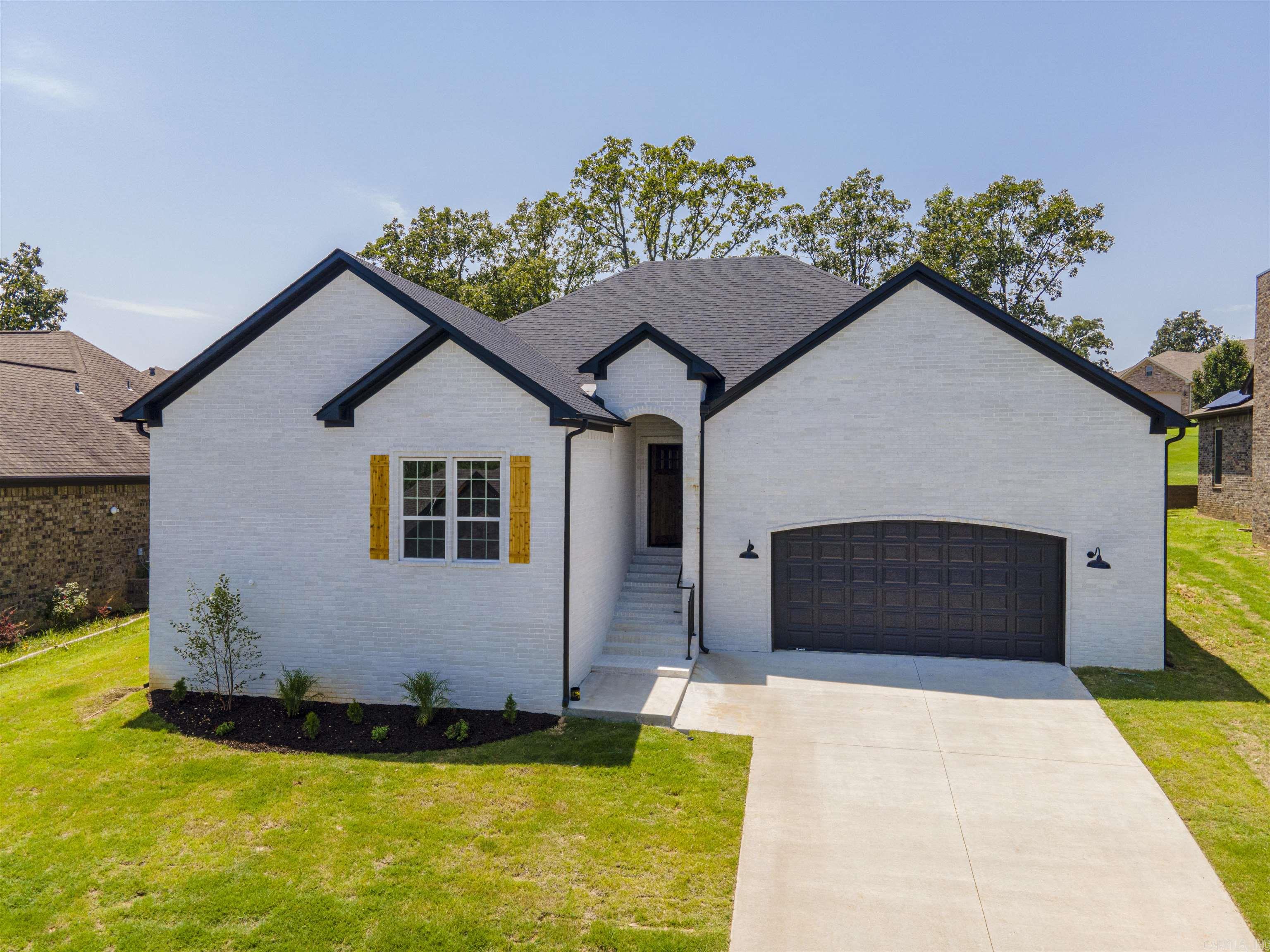 Gorgeous light colors with wood and black accents are in this white brick, 1 story new construction home. 8817 Stillwater has an open floor plan form the living room to the kitchen and dining area. There are large windows that let the natrual light pour in and fill the home. The living room has a cozy fireplace and open shelving. The kitchen is incredible with white granite countertops and a wood wrapped island and the large dining area leads to the covered back patio & yard. The bedrooms have comfy carpet & the master ensuite has dual vanities a black spa tub, separate standing shower, and a walk in closet. There are 3 more bedrooms on the other side of the home for kids, guests, or home offices spaces and ALL of this is located in the desirable Creekside Subdivision in Sherwood that is close to everything and feels like a small community. Go see it today!