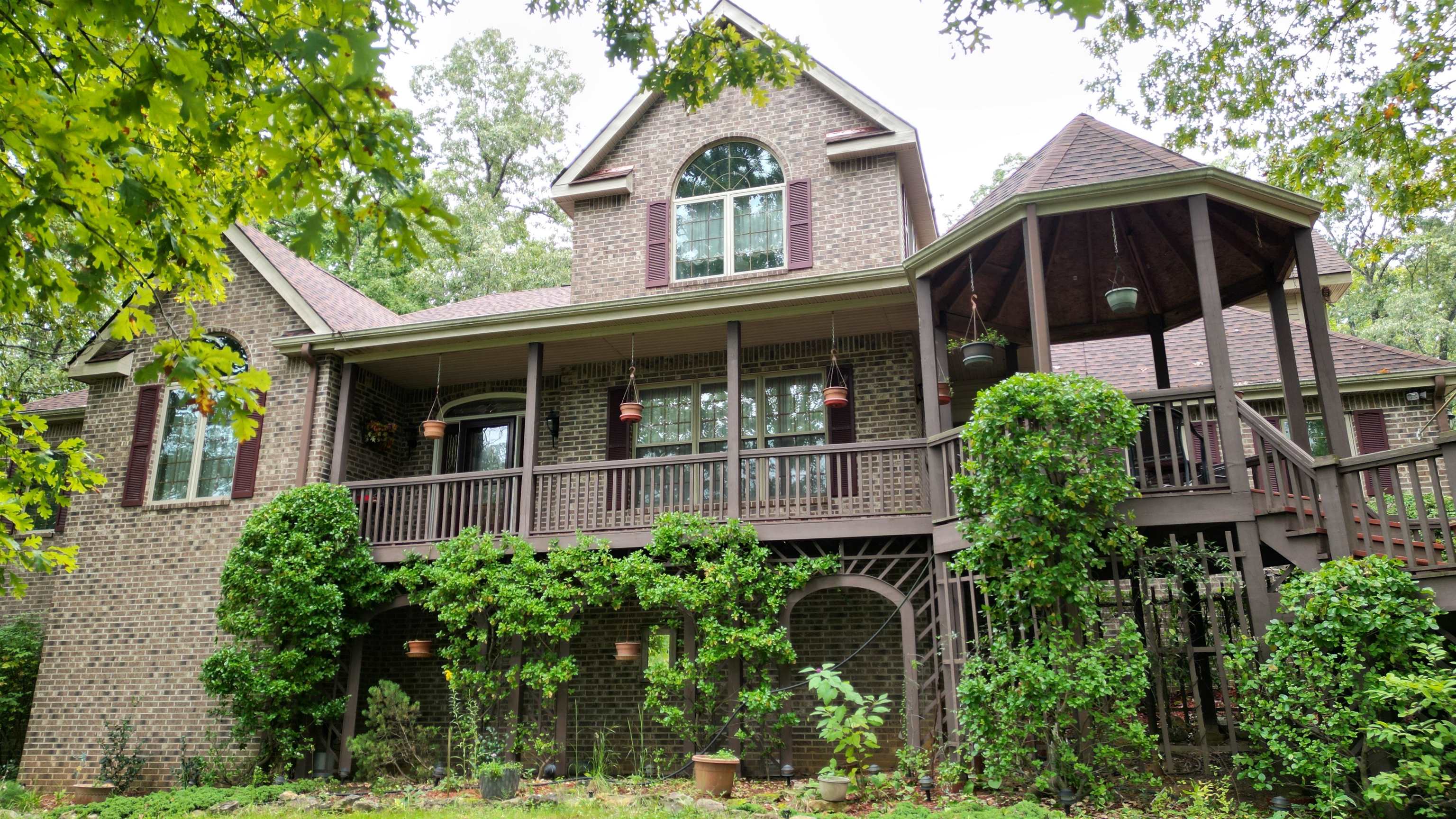 Discover luxury and tranquility on this 86.5 acre (m/l) property with a custom built 3 level home with a beautiful 5 acre lake. The expansive 5,407 sf home features 5 bedrooms & 3.5 baths and a fully finished walk out basement that has 9 ft ceilings & an additional kitchen, family room, game area and additional bathroom laundry room, perfect for entertaining or accommodating extended stays. The upstairs has a custom kitchen with, granite countertops, stainless steel appliances & downdraft grill in the island. The Primary bedroom has a large onsuite with whirlpool tub and separate shower. The living room has vaulted ceilings and a floor to ceiling native stone fireplace with french doors that open to the large deck. This home offers a perfect blend of style and functionality with fiber optic internet if you need to work from home. Whether you're enjoying the peaceful surroundings or taking advantage of the hunting and outdoor recreation opportunities, this property is an outdoor lover's dream. Don’t miss the chance to own this unique piece of paradise!