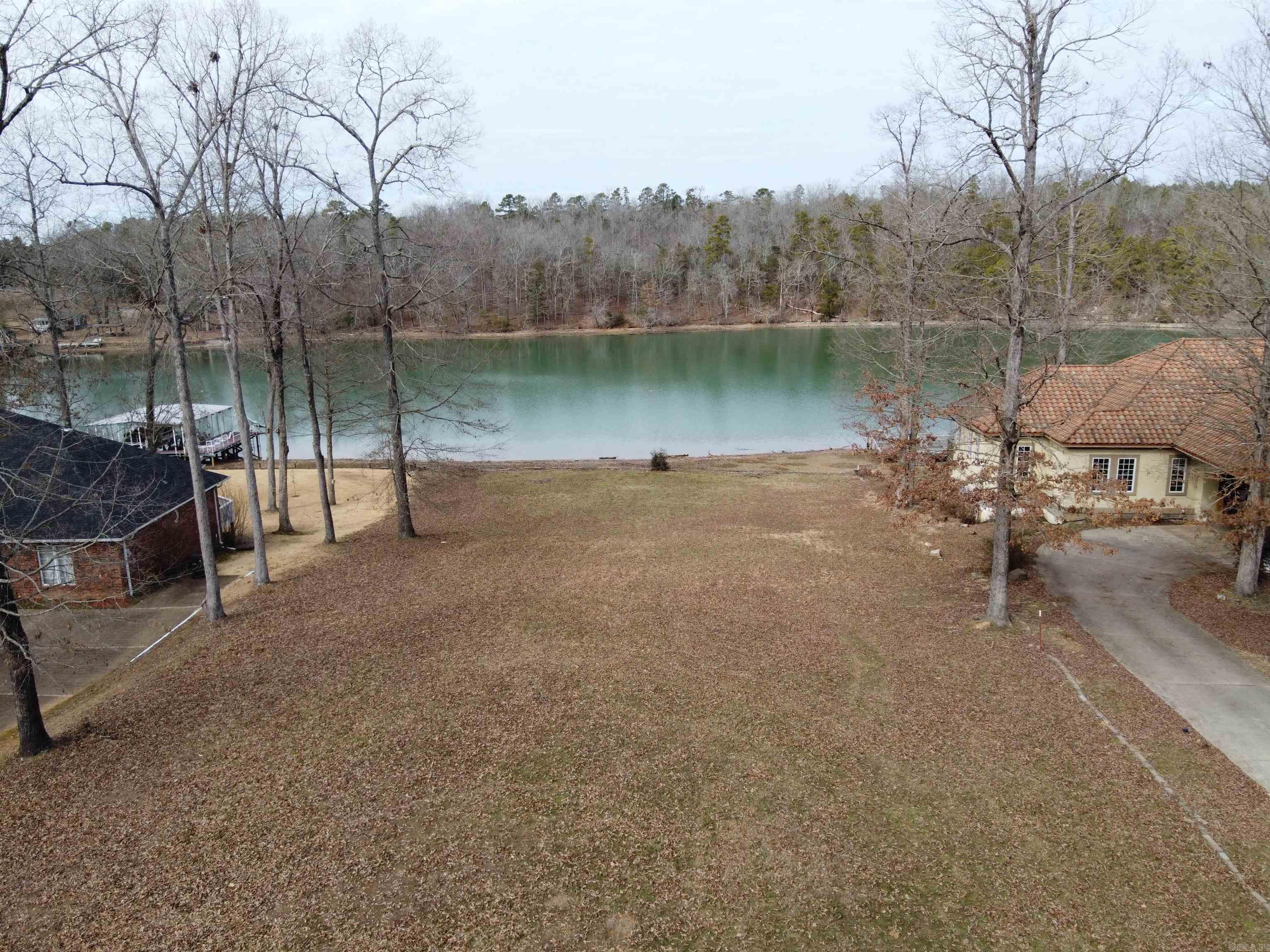 GORGEOUS VIEWS from this level LAKE HAMILTON lot with approx 120 feet on the water! Bring your house plans and get ready to enjoy living in the beautiful, gated Lake Forest Shores neighborhood. Seller has already applied for a 2 stall boat dock with Entergy. Don't miss this great opportunity!