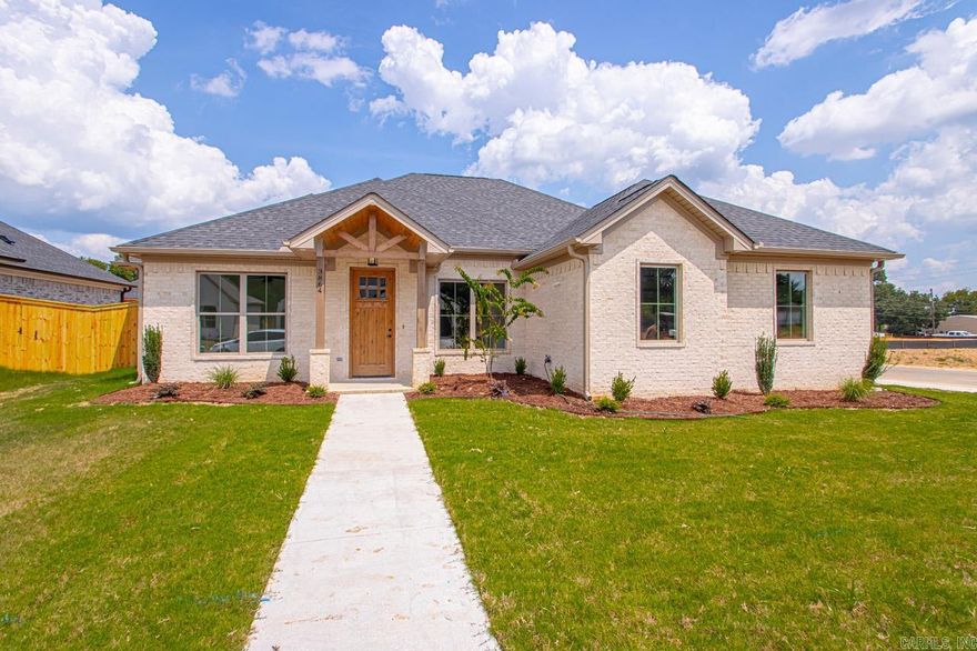 Welcome to your dream home in Benton’s premier subdivision, Spencer Crossing! This stunning brand new construction boasts a spacious split floor plan designed for modern living. Step into the heart of the home where custom-built, soft-close floor-to-ceiling cabinets adorn the kitchen, complemented by a freestanding stove & a convenient pantry for all your culinary needs. Cozy up by the brick gas fireplace in the open living area, perfect for entertaining or relaxing evenings at home. Retreat to the private primary suite featuring a luxurious primary bath complete with double vanities,  and a large walk-in tile shower, offering a spa-like oasis right at home. The split floor plan ensures privacy with spacious spare bedrooms, providing ample space for family or guests. Step outside onto the covered porch & immerse yourself in the tranquility of the backyard, where you’ll love spending time in the expansive, fully fenced outdoor living space. Whether it’s morning coffee or evening gatherings, this home offers the perfect setting for enjoying the outdoors. Don’t miss out on the opportunity to make this beautiful home yours!