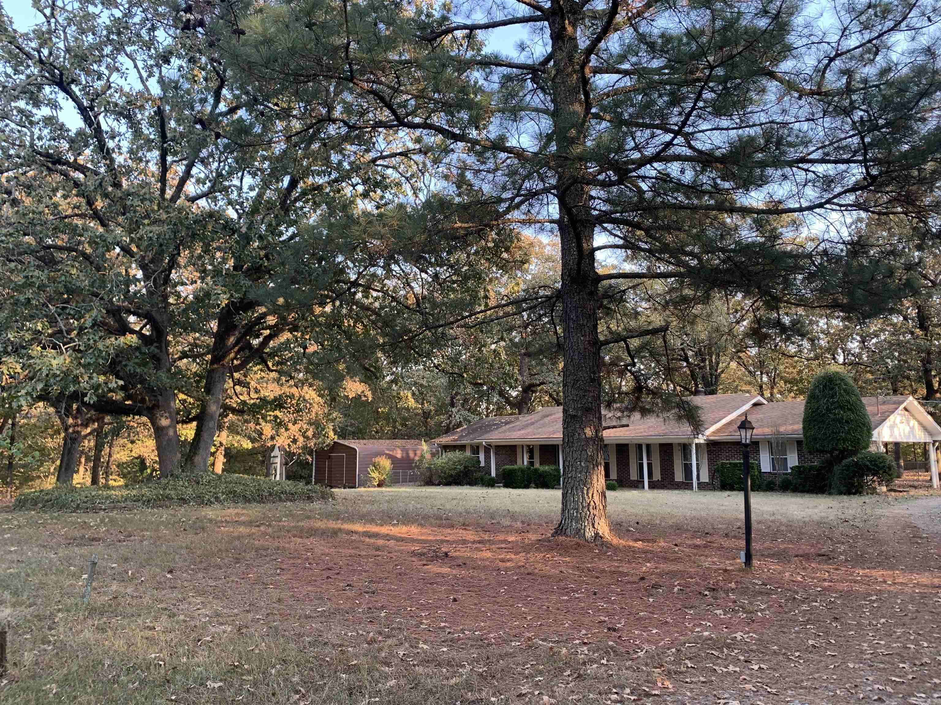 Beautiful home located next to Core of Engineers land, close to the Arkansas River in Clarksville, and close to Scranton, Arkansas. This spacious 3 bed/2 bath home is located in a private setting with over 3 acres. This charming home includes a large bonus/family room, large dining room/library, pantry with access to carport, laundry room, kitchen with nice appliances that convey, small shop and storage shed with electricity, additional carport, huge front yard, large fenced-in back yard, wood burning fireplace and much more! A new roof is currently being installed! Call/text to schedule your tour now!