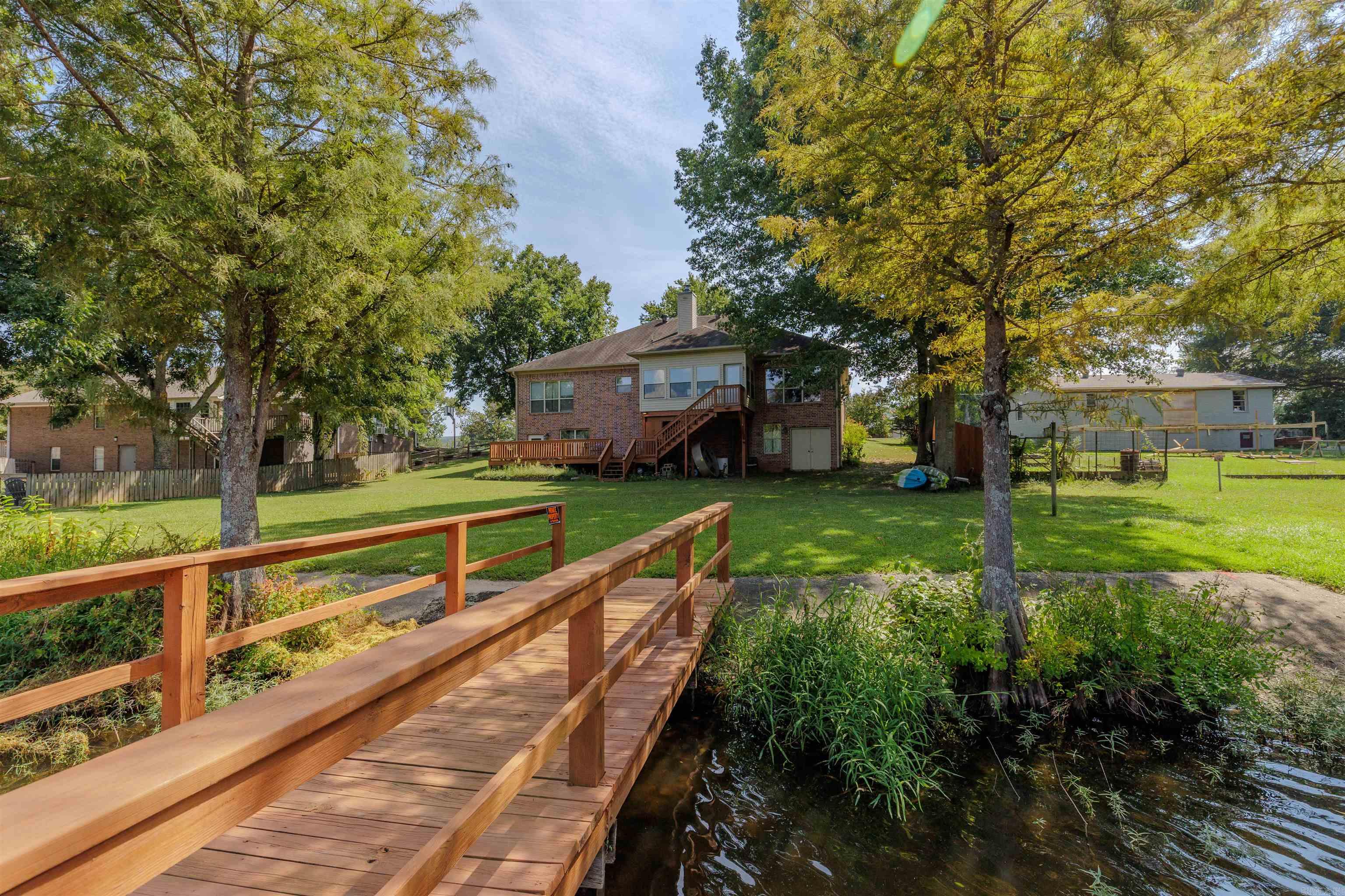 This lakefront home offers approximately 102 feet of frontage on Harris Brake Lake—the 3rd largest lake managed by the Arkansas Game & Fish Commission! Enjoy peaceful water views from the kitchen, living room, sunroom, and primary bedroom. The kitchen is equipped with rich wood-stained cabinetry, a gorgeous granite slab countertop, and a massive walk-in pantry just steps away. The open floor plan makes entertaining easy, while the enclosed, heated and cooled sunroom provides year-round enjoyment. The basement (approx. 680 sq/ft, not included in the home’s listed square footage) is also heated and cooled, complete with a stair lift for convenience. With walkout access to the back deck/yard on both sides, one section could easily be converted into a 4th bedroom. Experience true lakefront living while still being just a short drive to the Ouachita National Forest. Centrally located between Conway, Little Rock, and Russellville, with fiber internet available for your work-from-home needs!