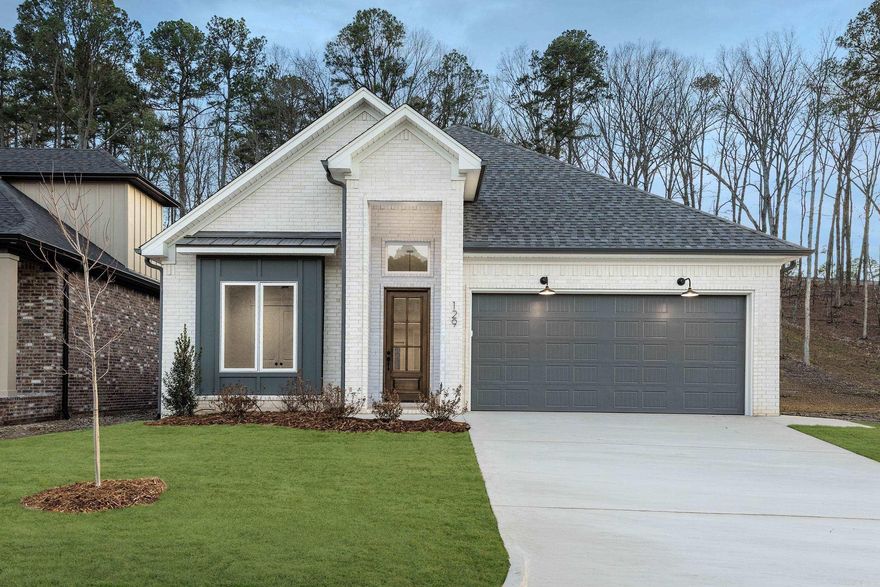 This thoughtfully designed home offers three bedrooms, two full bathrooms, and an additional powder bath, all arranged within a desirable split-bedroom floor plan. Tall ceilings throughout enhance the sense of space and light, while the open-concept layout seamlessly connects the kitchen and dining areas, making the home ideal for both everyday living and entertaining.  The kitchen features a walk-in pantry and flows effortlessly into the main living area, anchored by a gas log fireplace for warmth and character. Both full bathrooms are finished with custom tile showers, and the primary suite is further elevated by a freestanding tub that adds a touch of spa-like comfort.  Outdoor living is equally inviting with a covered patio and exterior fireplace, perfect for relaxing or hosting guests. The property backs up to peaceful green space, offering added privacy and natural views. A short walk leads to a community pool and park currently under construction, providing future recreational convenience right outside your door.