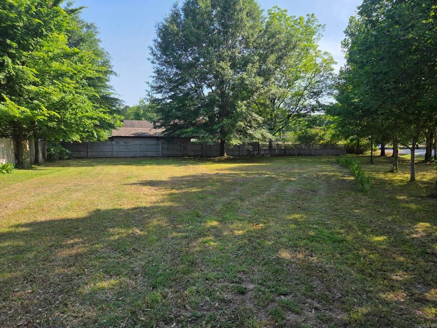 Nice level residential lot with no restrictions other than city restrictions. Could set a tiny home or build a 2-story house on it to have larger yard. Nice trees planted just off lines leaving the middle & back open for a house. City utilities of natural gas, electric & water are all available at the lot & a city sewer connection & culvert already in place for a driveway. The 2 sides are fenced so would be easy to have a fenced in back yard.