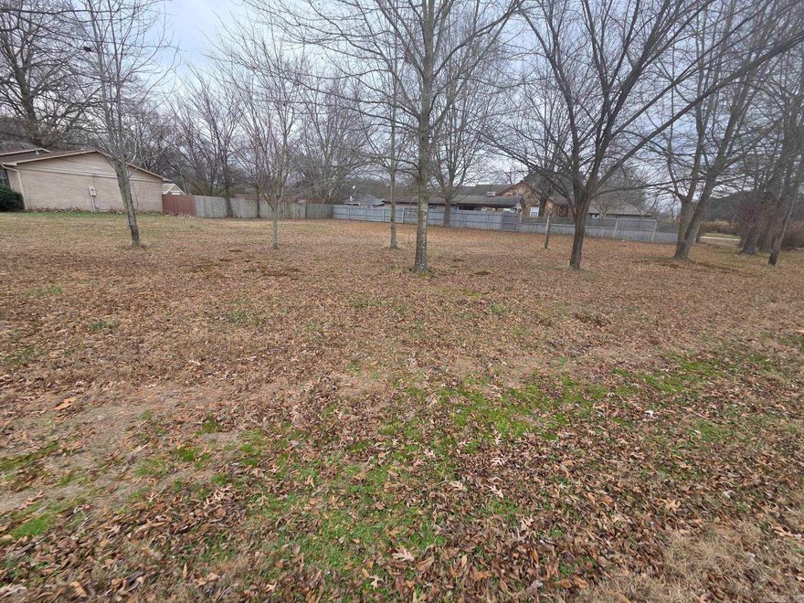 Nice level residential lot with no restrictions other than city restrictions. Could set a tiny home or build a 2-story house on it to have larger yard. Nice trees planted just off lines leaving the middle & back open for a house. City utilities of natural gas, electric & water are all available at the lot & a culvert already in place for a driveway. The 2 sides are fenced so would be easy to have a fenced in back yard.