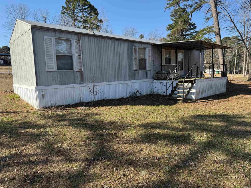 Mobile home on nice level lot. Located in nice subdivision and quiet neighborhood just down the road from the lake. Boat launch 3 minutes away. Property has RV hook up and a 24 x 34 shop with electricity. Would make good VRBO, Full time, or weekender. Drive by and give us a call today.