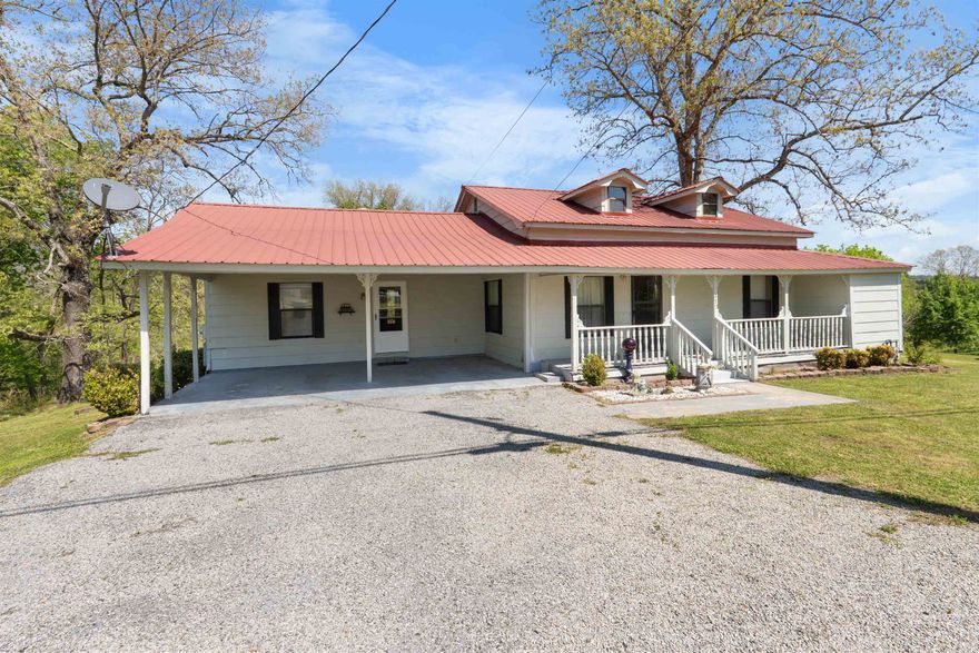 Charming 2 bedroom, 2 bathroom home situated on 2 acres within walking distance from Downtown Calico Rock and the White River! This home features an open concept living room and kitchen as well as an attached bonus room/den.  Both bedrooms include their own private bathrooms & one having a large walk in closet.   Step outside to enjoy a spacious back porch, ideal for relaxing and taking in the peaceful surroundings. The property also includes a 2 vehicle carport, a nicely landscaped yard, and one storage building that will convey with the sale. With its great location, functional layout, and scenic setting, this property is perfect as a full-time residence, weekend getaway, or investment opportunity!