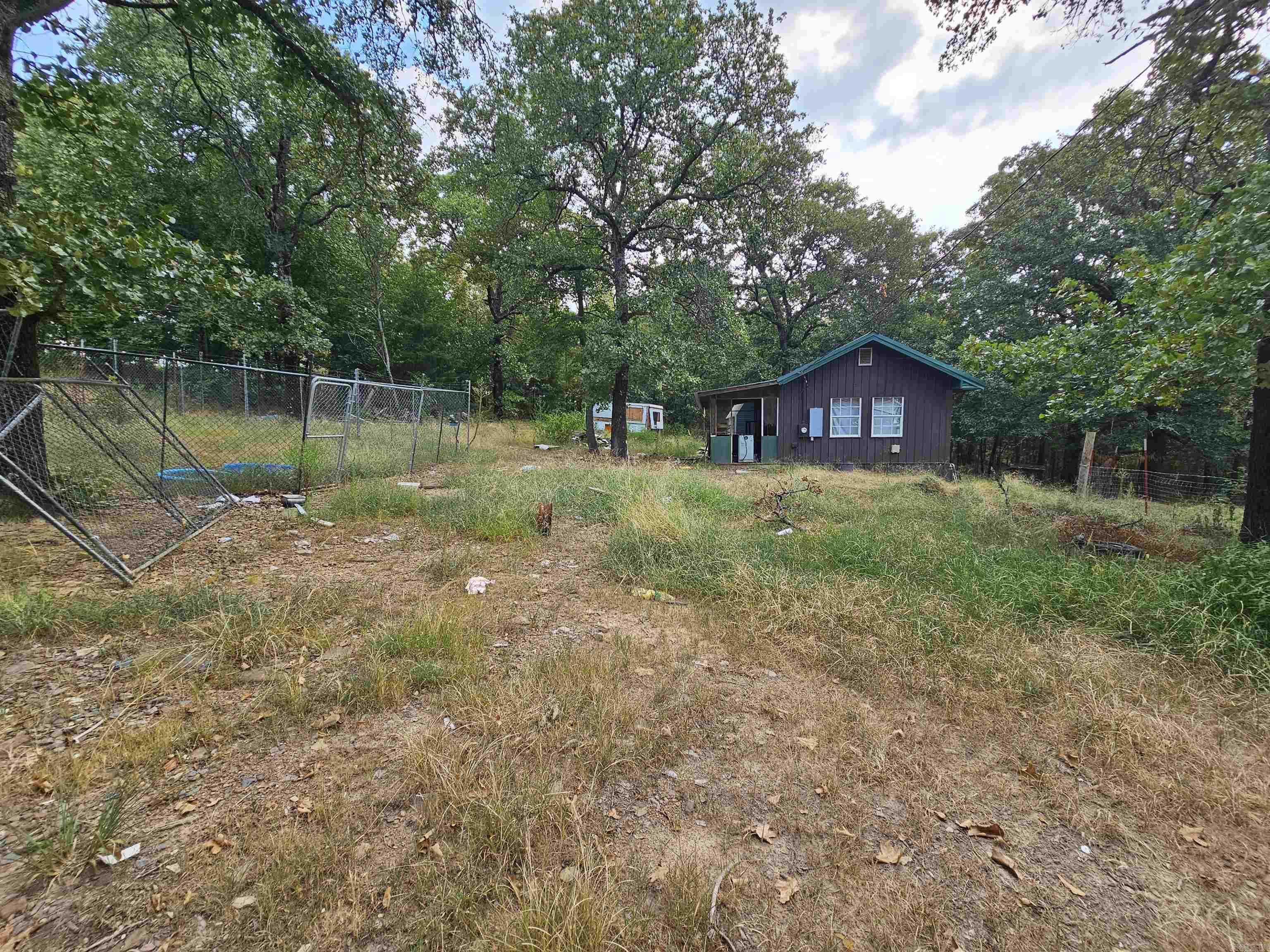 Tiny home on three acres! Country living outside of the city limits. This fixer upper tiny home has endless opportunities! This could be a hobby farm, air bnb, permanent residence or a great place for you to enjoy for the weekend to windows down and re-coop for your week. This property will require a clean up and TLC.