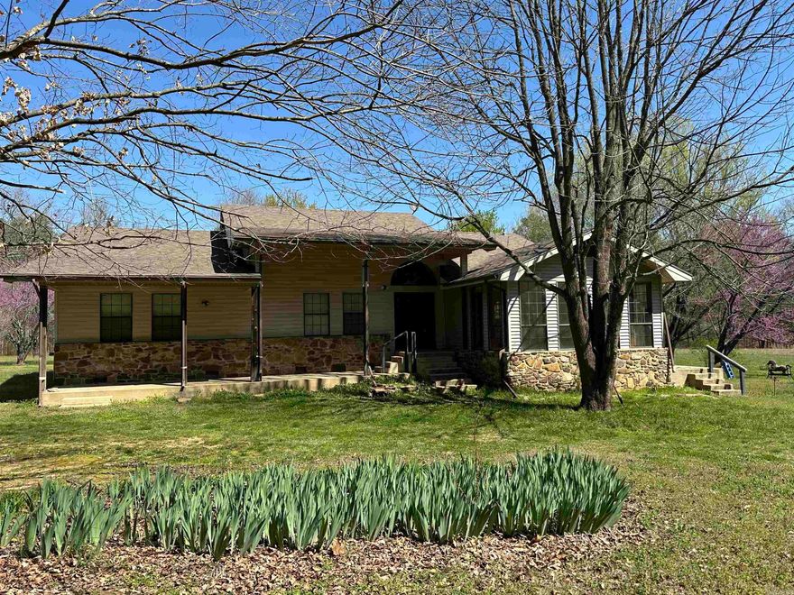 Custom-built home that could now be yours!Home sits on 13 +/- Acres, has a large, year-round creek along the backside of the property that makes a great playground for the family, has a nice pasture beside the house for a few livestock, a great garden area, has a nice orchard beside the house with apple and peach trees along with some berry bushes and asparagus that comes back yearly.With this yard being so level and shaded, you could enjoy any time of the day out in the yard!  With this year-round creek in your backyard, you can trout fish or swim in privacy!  You are just minutes from the White River & Lock and Dam (one could walk).There is a small outbuilding for storage as well.As you walk in, you will see the high ceilings and the gorgeous woodwork at first glance from the foyer.Kitchen off the foyer, with custom cabinets, lots of drawers, lots of counter space, a large laundry room off the kitchen, a sun room,nice office/dining room.The living room is large and has custom wood beams and a large native stone wood-burning fireplace, unfinished (needs paint, trim around windows)den area(it is heated/cooled),3 bedrooms 2 bath down hall.Just down the road from Mountain View!