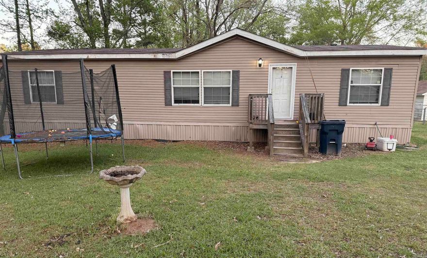 Discover the perfect blend of comfort and peaceful country living with this charming home, ideally located just outside of town. Featuring an oversized living room, this home offers plenty of space to relax or entertain. Enjoy the outdoors with built-in front and back decks. The spacious master suite is a true retreat, complete with a luxurious en-suite bath that includes a jacuzzi-style tub, walk-in shower, dual vanities, and two walk-in closets. With 3 bedrooms and 2 bathrooms, this home provides both comfort and functionality.