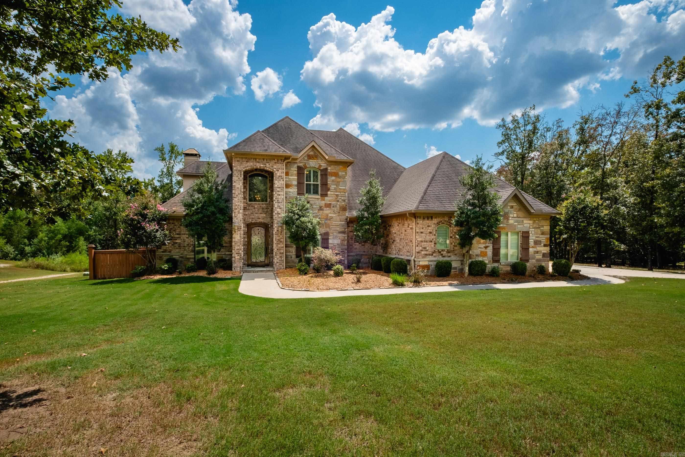 Exceptional home on 5 acres in the Westcliffe subdivision. This home has a deck overlooking large pond. Covered porch has views of oversized pool with diving board area, sport court area, hot tub and sunbathing area. Main level boasts arched brick openings, dining room, office with coffered ceiling, hearth room has oversized fireplace with open kitchen. Main level primary bedroom with sitting area and large luxurious bath. Upstairs has two bedrooms with shared bath. Additional bedroom with hall bath that shares with bonus room (this could be 5th bedroom) and balcony overlooking pool. Fenced area for dogs. Home has three car attached garage. Separate detached garage/workshop 1546sf with room for 7-8 cars or drive your boat through front and back garage doors. Efficiency apartment/in-law quarters with full kitchen, full bath, laundry and storm room. This has it all. Come see!