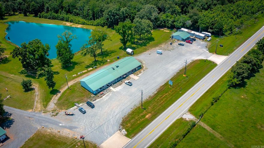 Commercial Property Built-to-Suit many different needs & was built in 2014. There is 5,000 sqft heated & cooled plus FIVE 1/2 baths.   Currently being used as a Flea Market (Depending on the timing of the sale, the items that are currently at the store at that time will stay at a a negotiated price).  The property has a septic easement on the neighboring land and the easement is a $30,000 system & was designed to be large enough for a restaurant. This property has been used in the past for 2 different restaurants..... "The Eagle's Nest Restaurant" as well as "The Boar House Restaurant".   Come Check it out if you would like to run a business near Beautiful Greers Ferry Lake.