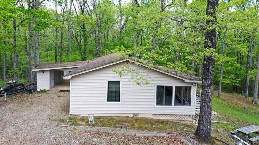 Perfect getaway near beautiful Lake Ouachita in Mount Ida, AR! Whether you're looking for a full-time residence, vacation home, or an income-producing VRBO, this property checks all the boxes. This move-in ready home has been thoroughly cleaned, including all carpets, and is ready for its next owner. Inside, you’ll find two spacious living areas, including a stunning enclosed sunroom with a wall of windows overlooking access to Twin Creek—perfect for relaxing and enjoying the natural surroundings.  Property has easement to access Twiin Creek with trails, creek access and wildlife. The home features two bedrooms and two newly remodeled bathrooms, along with a convenient side-entry mudroom with storage and a separate laundry room. Outside, the property offers a carport with three storage areas, providing plenty of space for tools, lake gear, or hobbies. A separate bunkhouse adds even more versatility—ideal for guests or additional rental potential. Don’t miss this opportunity to own a slice of paradise near Lake Ouachita