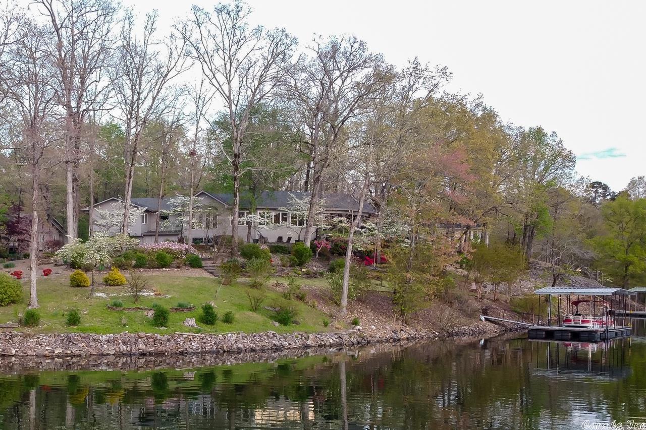 Come live the resort life in this luxurious lake front home on 1.34 acres overlooking Cortez Lake with 378ft of shoreline. Located in a quiet and friendly neighborhood. Enjoy the breathtaking lake views and sunsets from the covered trex deck. This predominately one-level home has 4 bedrooms, 3.5 bathrooms, formal dining room, office/bonus room, hearth room with gas FP. Hardwood floors throughout. Expansive lake views from many rooms! The spacious kitchen boasts granite countertops, gas range stove, wall oven with warming drawer below, farmhouse sink, stainless steel refrigerator, dishwasher, coffee bar, beverage refrigerator and plenty of storage throughout. The spacious master suite hosts 3 closets, laundry area, large bathroom with double vanities, soaker tub and step in shower. Additional features include a covered boat dock with 10' swim deck, 4 car garage, immaculate landscaping, lake fed sprinkler system, 8x12 storage shed, hot tub and a custom stone patio for grilling and entertaining. Roof replaced in 2020, Water Heater 2021, New HVAC 2022. First time HSV property owners are subject to a one-time $1,500 buy-in fee at closing. Don't wait to schedule your showing!
