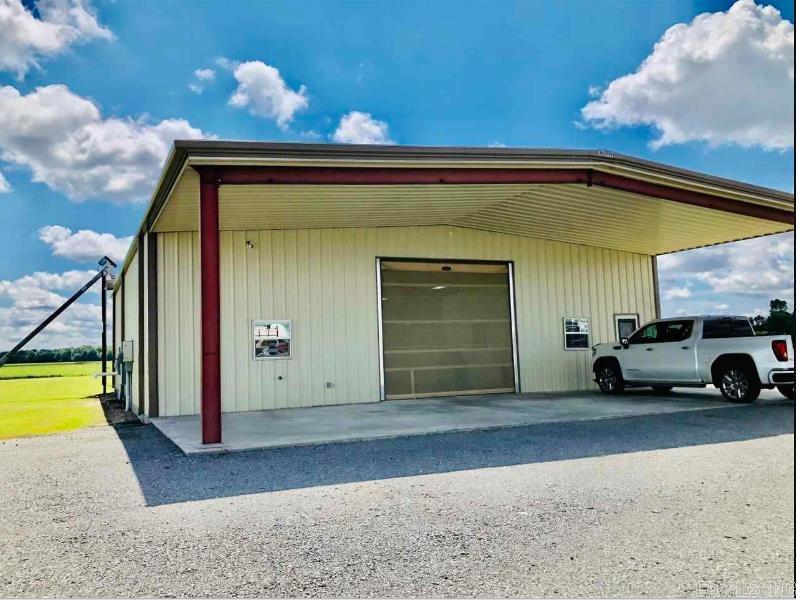 Newer constructed 3000 sq. ft. metal shop building with 15x15' office, heated/cooled kitchen, concrete foundation, huge shop with large entry and exit doors with full screens, 10 camera Simplisafe security system and monitor, wireless phone & internet, exhaust fan, sealed floors with drains, motion detectors on windows, soft water system, alarm system, food grade facility, 10,000 bushel grain bin with auger, 2,000 gal. septic system, beta cable, Direct TV, exhaust system, easy access to I40, .99 acs. Heated building with office space as well. The building is amazing and will fit just about any business.