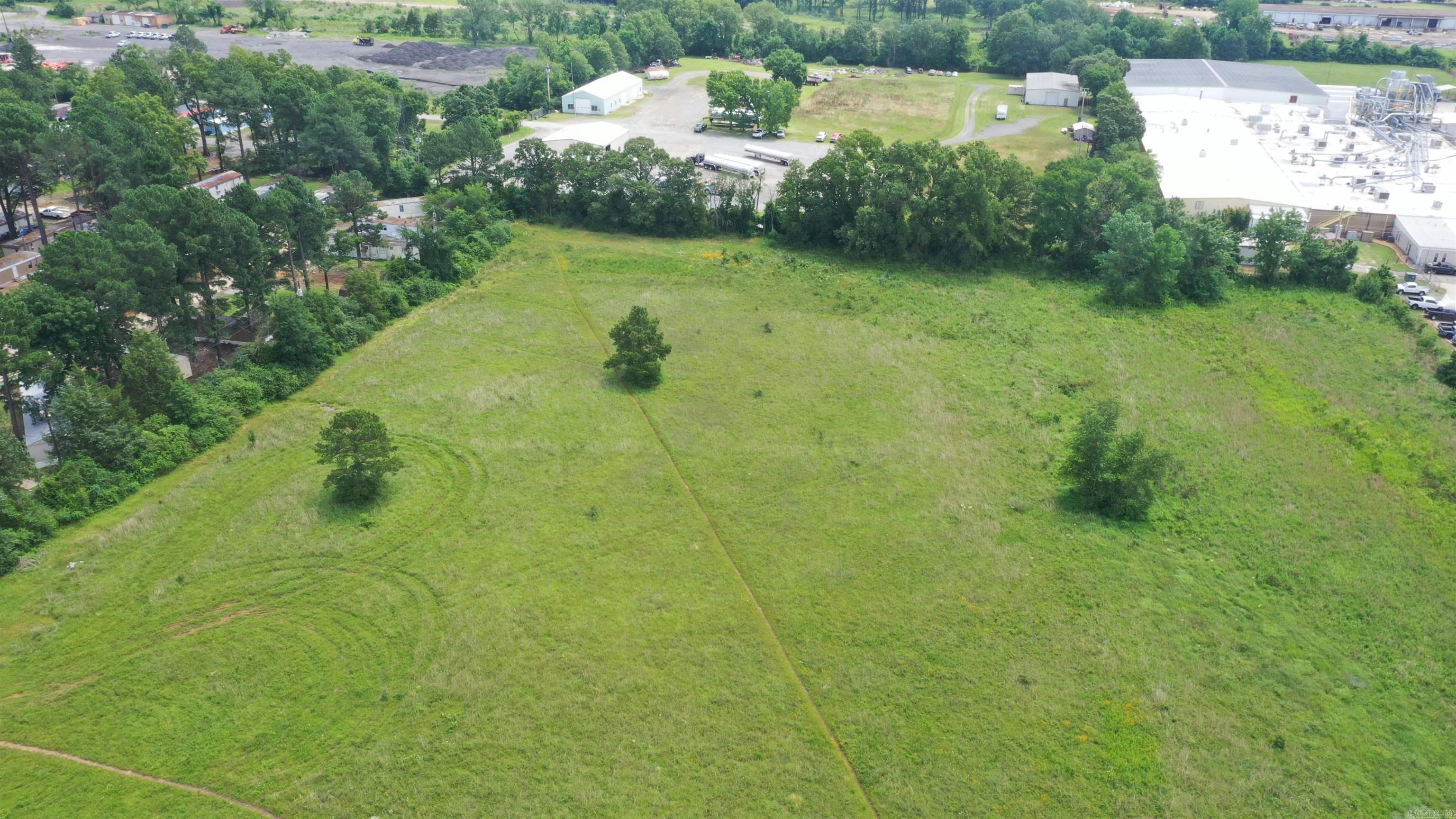 ZONED C-3. This property has many possibilities for commercial development. Great place for Storage units for Boat or RV storage, large construction company, trucking company, etc. It is conveniently located only minutes from I-40, hospital, industrial Park, and downtown area. See survey attached to documents. Drone pictures available. Attractive for any business seeking accessibility and high traffic area. Call listing agent for more information or questions. See virtual tour video.