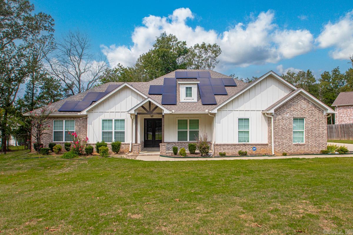 The one everyone has been asking for. Not too far out! Country feel. Over an Acre! No restrictions! Corner style Lot! This 4 bed 2 1/2 bath home has it all. Walk thru the front door to an open living, kitchen, dining room. Today's style kitchen featuring quartz counter tops. Wall oven with an electric surface range. A huge pantry to top the kitchen off. The half bath sits just off the kitchen/living area. Plenty of closet space in the primary suite. On the other side of the home are the three spare/guest rooms. The living room features a wood burning fireplace and wood beams traverse the ceiling. Outside you'll find a covered back patio with a chain link fenced back yard. Plenty of space on the lot to build your dream shop. The home includes solar panels at no cost to the new home owner! Schedule your showing to see this one today.