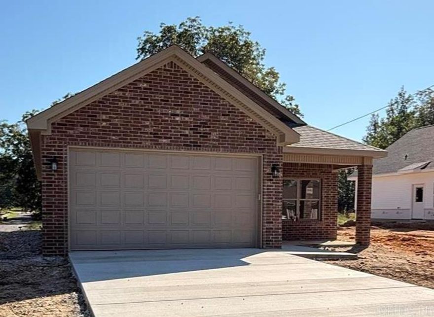 New all-brick construction on a level lot! This 3BR/2BA, 1,253 sq ft home offers a vaulted ceiling in the kitchen and living area, large pantry, granite countertops, and custom cabinetry. Each bedroom features a walk-in closet, plus there’s a spacious laundry room and two-car garage. Built with spray foam insulation for efficiency and a wheelchair-accessible design for convenience. Includes a 1-year builder’s warranty—move-in ready!  Landscaping and sod to be completed early October.
