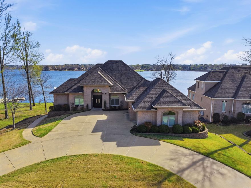 Experience lakefront living in Benton’s prestigious Hurricane Lake Estates! This stunning 5-bedroom, 4-bath home offers over 5,400 sq ft with breathtaking water views and beautifully designed living spaces. Inside you’ll find soaring ceilings, expansive windows, and a spacious kitchen with abundant cabinetry and prep space—perfect for entertaining. The primary suite is a private retreat overlooking the lake with a spa-like bath and generous closet space. Built with energy-efficient ICF construction, the home offers impressively low utility costs. Premium features include a private elevator, whole-home generator, safe room, water filtration system, irrigation, and abundant storage. Enjoy outdoor living with a level landscaped backyard, retaining wall, EZ floating dock, and peaceful waterfront views. Recent updates include a bath remodel, sprinkler system, and tankless hot water heater.