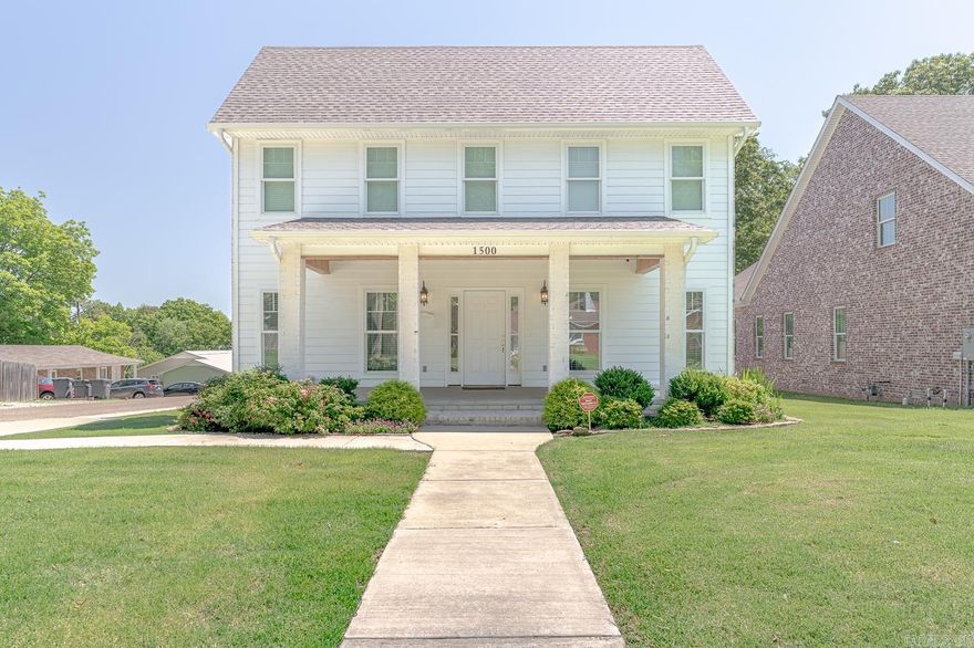 Welcome to Market 1500 S Church St of Jonesboro, AR within the Jonesboro School District. Situated on a .44 +/- acre fenced corner lot in the heart of midtown is a 2021 built Colonial Revival wrapped in brick & hardie board, topped w/ architectural shingles and accented by a covered front porch, 2 wood decks off the back, guttering, gorgeous landscaping, 2 car side entry garage, parking pad, and walkway. The interior features 3,082 sf of well laid out living space over 2 floors. On the main is an open concept living/kitchen area. The eat-in kitchen holds bar seating, stainless steel appliances, Corian countertops, backsplash, custom cabinetry and access to the deck, formal dining room, Master w/ en-suite featuring a walk-in closet, custom walk-in tiled shower, & dual vanity, spare bedroom w/ deck access & dual closet, spare bathroom w/ walk-in shower, and laundry room. Upstairs holds 3 bedrooms w/ walk-in closets, gaming/study area, spare bathroom w/ shower/tub combo, and floored attic space. You'll love the tall ceilings, security system, lawn sprinklers, and more. Conveniently located near favorite local amenities. Call today to schedule your tour and make this house your home.