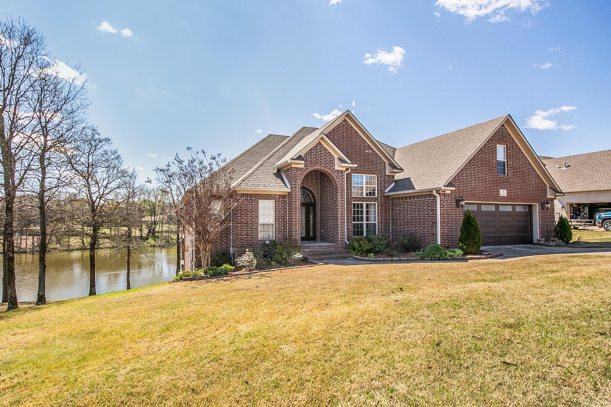 This beautiful home is located in a desirable neighborhood and overlooks the water! It is spacious and has a well-designed layout. Three bedrooms are downstairs including the primary bedroom. One bedroom, a full bathroom and oversized bonus room are upstairs. As you step inside the foyer, you are greeted with a living area that features lots of beautiful crown molding, high ceilings and a fireplace as the focal point. The formal dining area is also open to the living space. The kitchen has stainless steel appliances, granite counter tops, pretty backsplash and a breakfast nook. The primary suite is spacious and offers a private en-suite bathroom with separate tub and shower, dual sinks, and walk in closet. For those who enjoy outdoor living, this home is perfect! The backyard has a covered double patio overlooking the water and a new dock on the water. Fish from your own backyard! Call today and make this one yours! Agents - please see remarks.