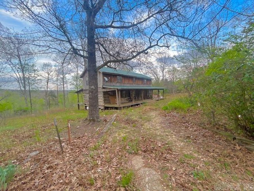 Charming log cabin is a fixer upper on approximately 34 acres m/l featuring beautiful, well-laying land with scenic mountain views, blooming flowers, and a variety of fruit trees. The property includes a pond, barn, and storage shed—making it ideal for a small farm, homestead, or peaceful country retreat. Located in the friendly community of Fox, AR, offering a country store, post office, and a well-regarded school. The lower part of the cabin was built in the Civil War Era and even has a secret shooting hole in the kitchen wall. Very cool place. You can enjoy the privacy of country living while being just 25 minutes from Mountain View, known for its local shops, restaurants, and live music on the square. Conveniently situated near the Little Red, White, and Buffalo Rivers, with Greers Ferry Lake only 30 minutes away.  A great opportunity to own a versatile property in the heart of the Ozarks with both natural beauty and modern convenience.