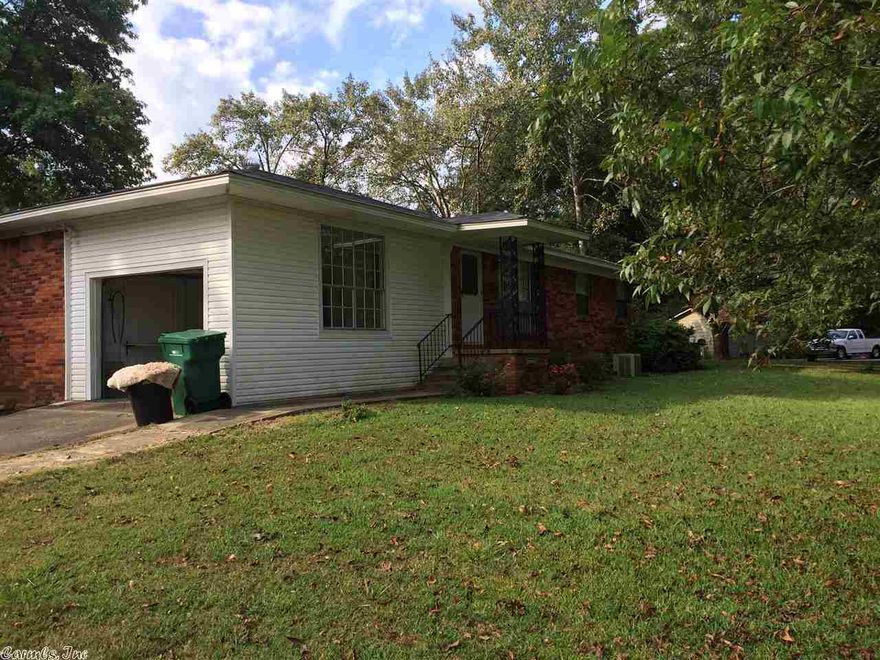 Brick house on 4.23 acres, pecan grove in front yard with 2 barns/workshop, nice deck on back. Fenced.