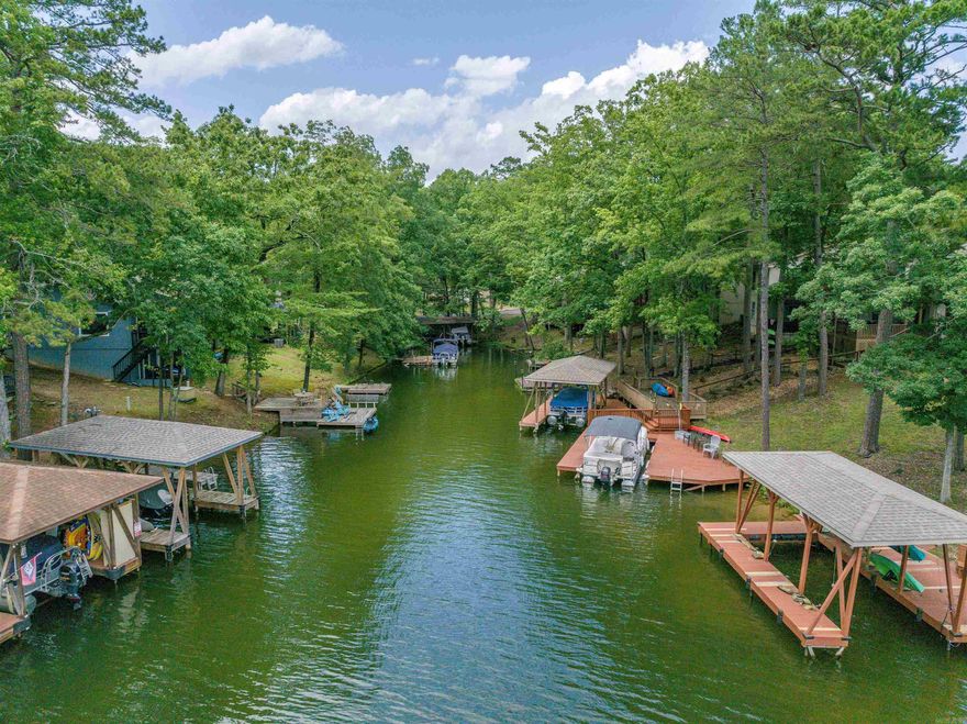 3 Bedroom WATERFRONT townhome on Lake DeSoto! Enjoy Sunsets from your Back Deck or the Lower Patio! BRAND NEW ROOF! These units make great Nightly Rentals! Primary Bed with Deck access and Bath are on the main floor, with 2 more Bedrooms and Full Bath on the Lower Level. There is also an oversized Laundry/Storage/Owner's Room (in addition to the 3 Bedrooms). Lake DeSoto is one of 4 Full Recreational Lakes in Hot Springs Village (water ski lake)! This 200 acre lake offers a Beach, the Waypoint Marina, Boat Launch and Walking Trails! Hot Springs Village boasts 11 Lakes & 9 Golf Courses, Tennis, Pickleball, Mini Golf, Bocce Ball, Lawn Bowling, Dog Park, Fitness Center, Indoor & Outdoor Pools, Performing Arts Center, Archery Range, 20+ Miles of Walking Trails, and much more!