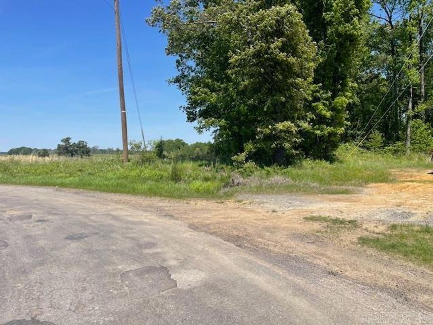 Great location with huge oak trees on roughly 15 acres to build your home.  Grand Prairie Water and Entergy are available. Located off paved road. In the Carlisle School District.