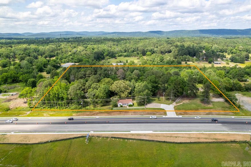 Fantastic Commercial opportunity!! Just listed on the market. Over 5 1/2 Beautiful Acres with a view in a booming business area with a high traffic count on the newly widened Hwy 270 . Well built house could serve as an Office. Separate Storage Building with Well.