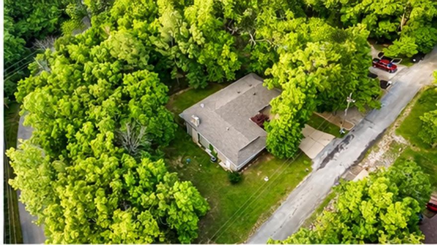Beautiful setting for this well-maintained 3-bedroom (w/ room in basement that could be 4th), 3-bath home in the heart of Cherokee Village, AR, on a large corner lot, offering approximately 2,600 sq ft of living space & designed for comfortable family living or entertaining. Home features a custom kitchen w/ newer stainless steel appliances, abundant cabinet space, & a cozy gas log fireplace. A large 2-car garage, two back decks overlooking a spacious yard, & an enclosed backyard provide great outdoor enjoyment.  The finished walkout basement features a living room area with 2nd gas log fireplace. The bonus room can be used as a 4th bedroom, complete w/a huge walk-in closet that also serves as a storm room, a full bath, & an office area, + a large workshop & tons of storage throughout. The roof was replaced in '23, adding peace of mind.  The home features energy-efficient enhancements through Entergy's Weatherization Program in 2025.  This home is less than 700 feet from the North Golf Course, just west of the South Fork River, and north of Cedar Valley Park, with tennis courts and walking trails nearby. It would be hard to find a better location in Cherokee Village.