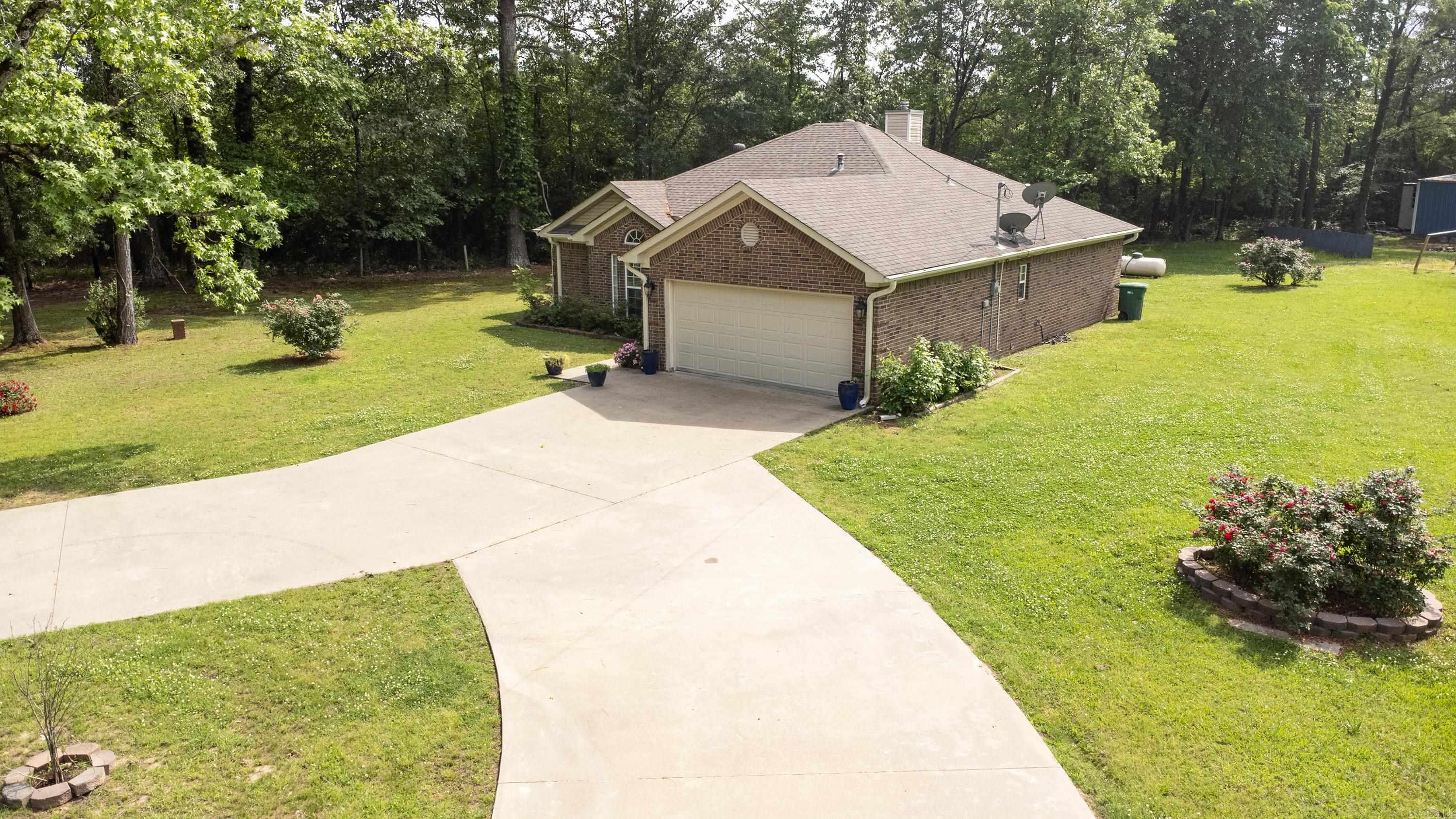 This inviting 3-bedroom, 2-bath home sits on a generous 4.14-acre corner lot, offering privacy, space, and endless possibilities. Enjoy the recently added screened-in back porch, perfect for relaxing and entertaining in comfort outdoors. The property includes a large workshop/storage building, ideal for hobbies, storage, or even a home-based business. Whether you're looking to build additional homes, host large family gatherings, or simply enjoy the peace of rural living, this property provides the flexibility to make it your own. The expansive driveway offers extra parking, and the location gives you the quiet of the countryside with room to grow.