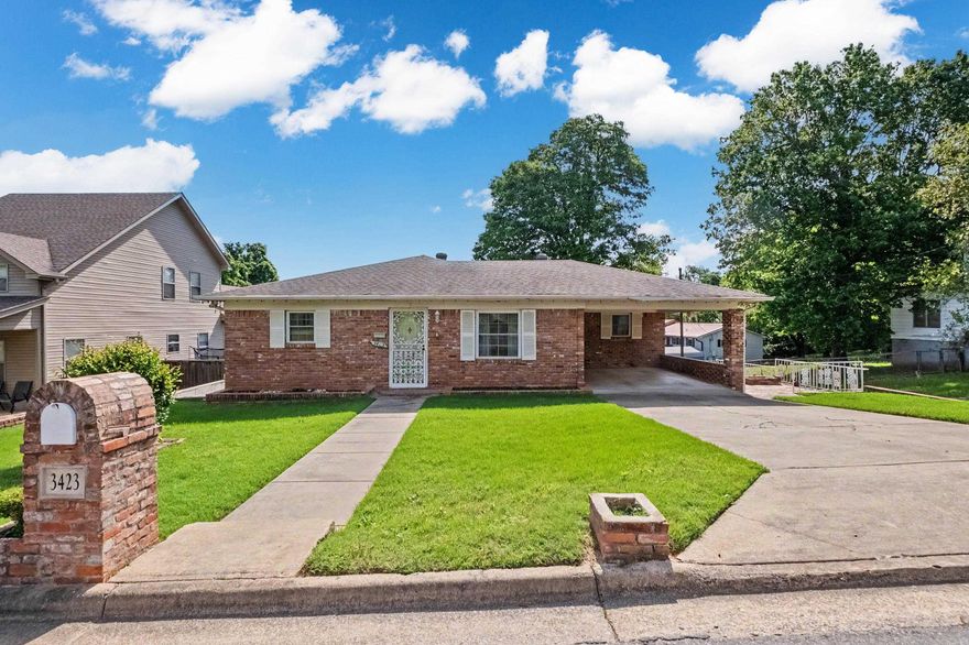 Beautifully cared for all brick home on corner lot offers 3 bedrooms, 2 baths and two living spaces. It has ample living room space, separate dining room and comfortable den/family room, along with an eat-in-kitchen.  Primary bathroom has been nicely updated. A dedicated laundry room.  Pretty wood floors and ceiling fans throughout.  This great layout makes it comfortable and convenient.  Large corner lot adds extra outdoor space with built-in grill is great for entertaining, gardening or just relaxing and enjoying.  Big brick patio. Yard also contains a sprinkler system.  This one is a great family home and deserves a good look right away!