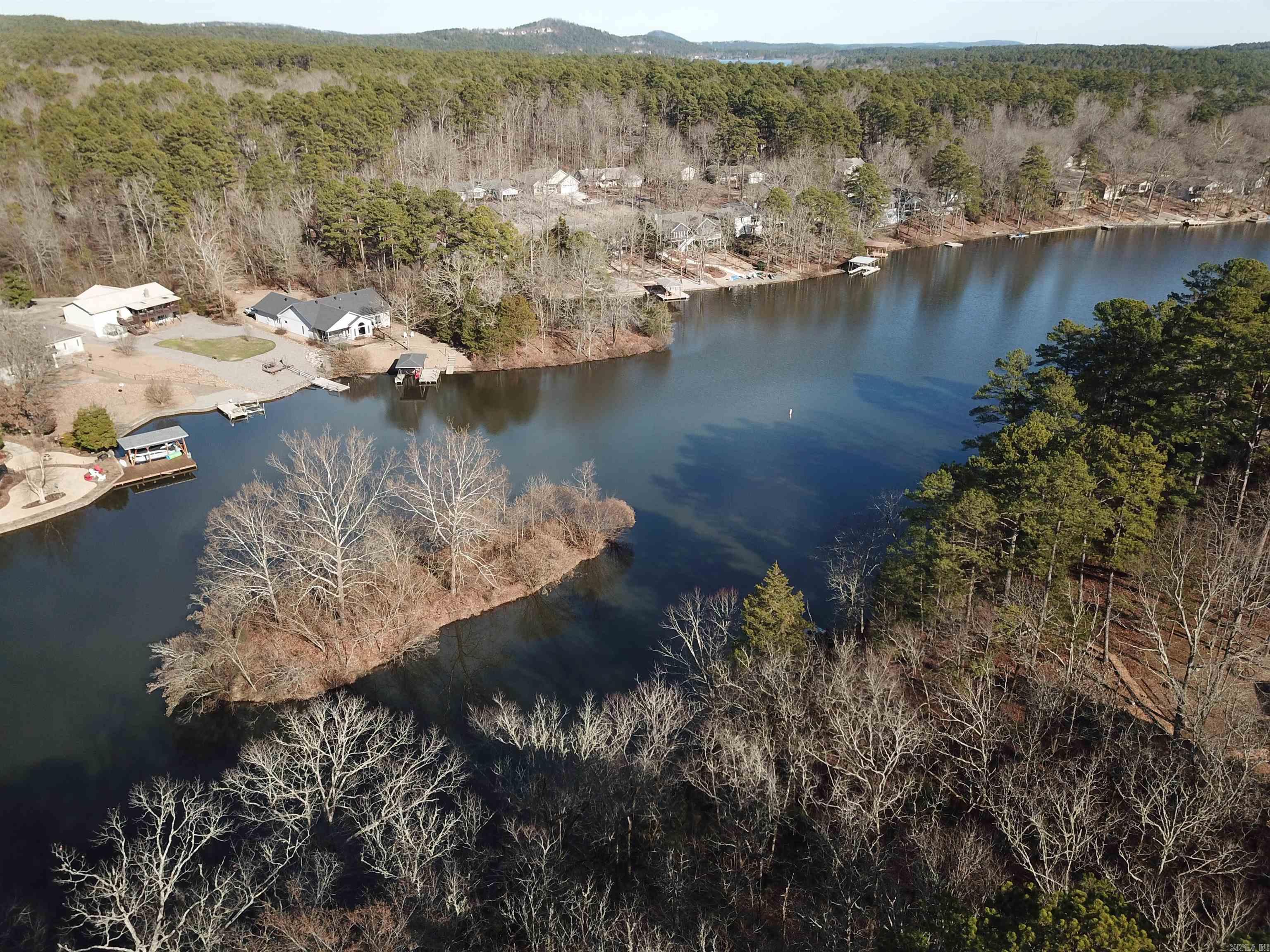 Great opportunity to purchase lake front property on Lake Pineda. Want more space? The lake lot next door (24 Cuenca) is also available for sale. Lot is centrally located and just minutes from the Coronado Fitness Center. Hot Springs Village is a gated community with 9 premium golf courses; 12 lakes; 30+ miles of walking trails; fitness center with indoor pool; tennis center and so much more! Come see all that the Village has to offer. See Associated Documents for copy of Elevation Map showing slope on lot. Measurements are in 2 foot increments.