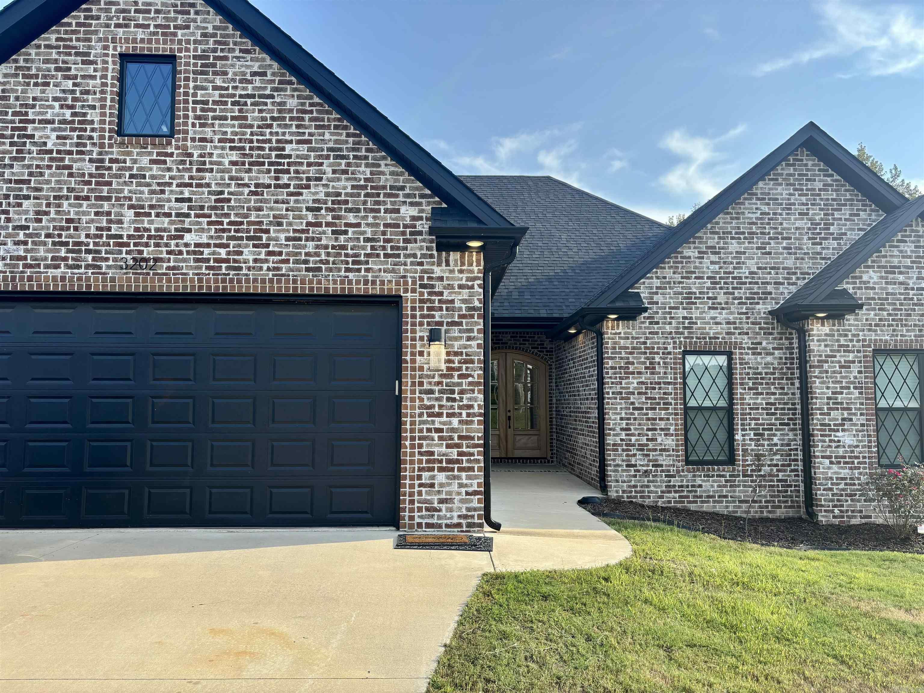 Introducing 3202 Fairview Rd in Paragould, a home that perfectly blends sophistication and comfort. Set on a spacious .46-acre lot, this residence offers 3 bedrooms, 2 bathrooms, and 2,130 sq ft of thoughtfully designed living space. You'll love walking through the 8-foot double wood doors into the bright, open floor plan. The living room features a cozy fireplace with a hand-cut mantle, perfect for relaxing evenings. The kitchen is ready for all your cooking and entertaining needs with Samsung appliances and gorgeous white quartz countertops. With luxury vinyl plank flooring throughout, the home is as stylish as it is durable. The oversized master suite has a huge walk-in closet plus a makeup vanity, while the bathroom feels like a spa with granite countertops, a freestanding tub, and a custom shower with glass walls. The guest bedrooms all have walk-in closets, and the garage was built with extra space for larger vehiclesplus it comes with a heated and cooled storage room. The big backyard is perfect for kids, pets, or hosting family get-togethers. This home truly has something for everyonecome see it before it's gone!